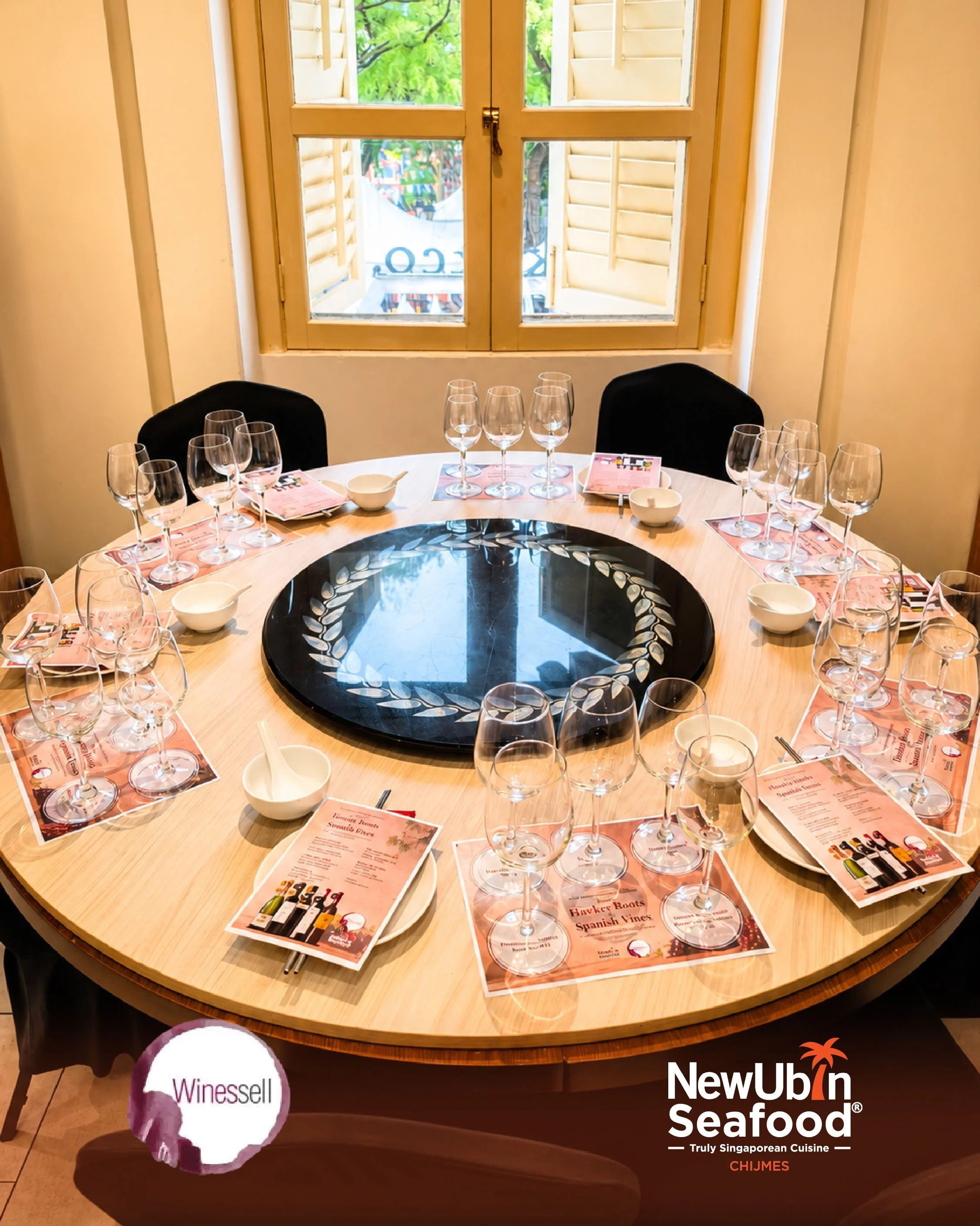 Round dining table set with wine glasses, menus, and small bowls during the wine pairing dinner at CHIJMES.