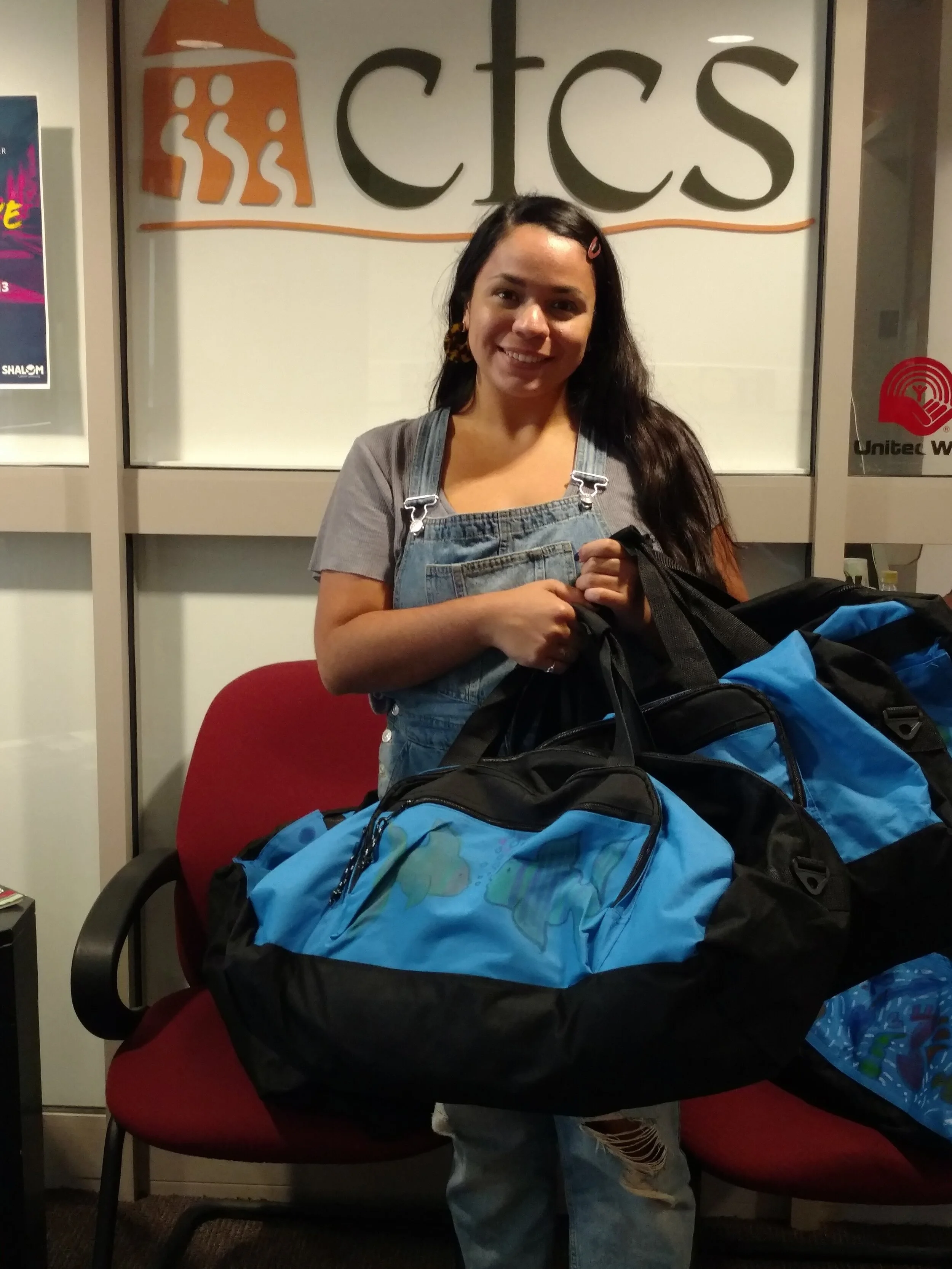 Family Support & Stabilization Coordinator Andrea Ruiz, picking up Sweet Cases for families