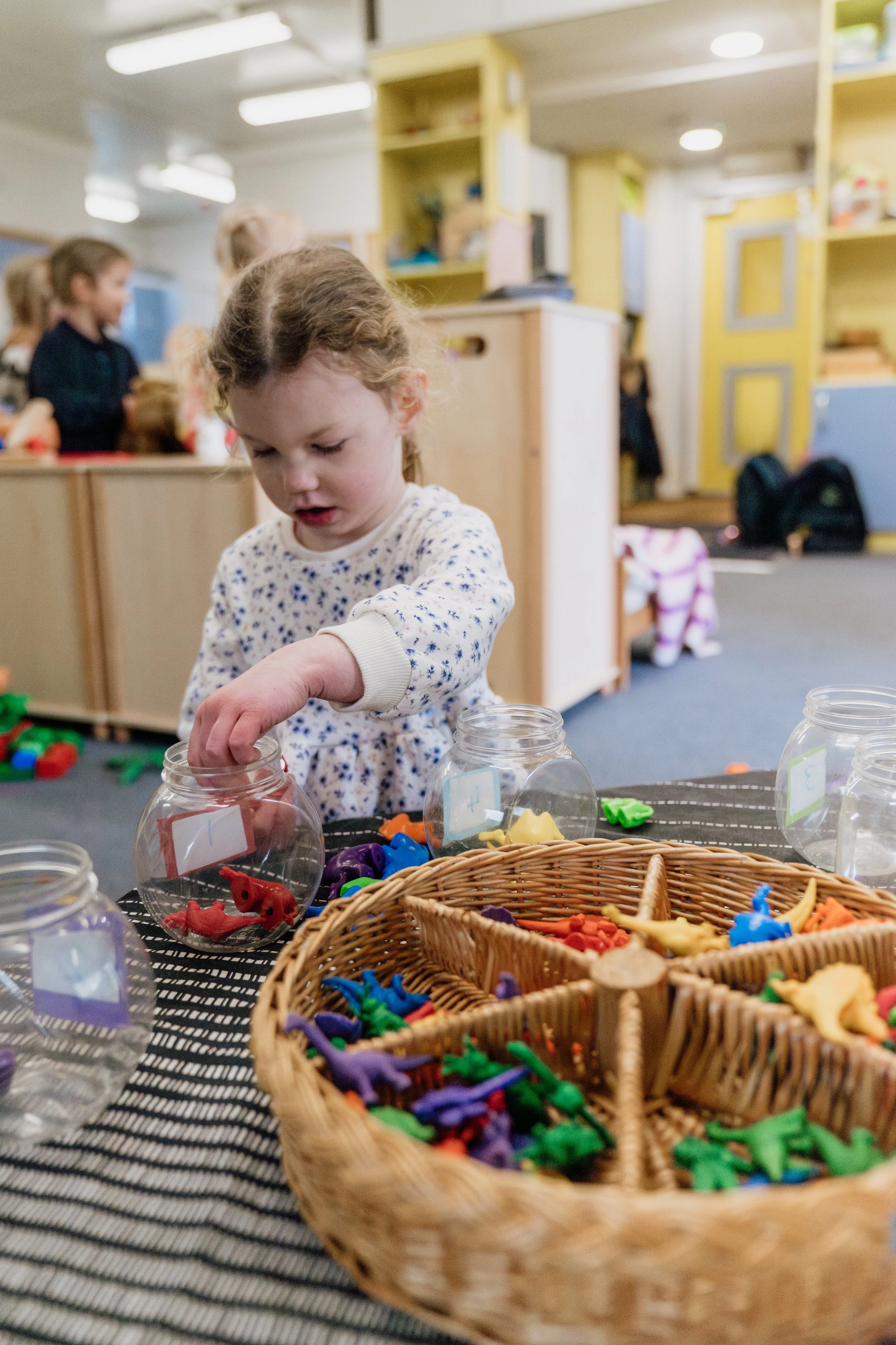 Girl-sorting-items-nursery