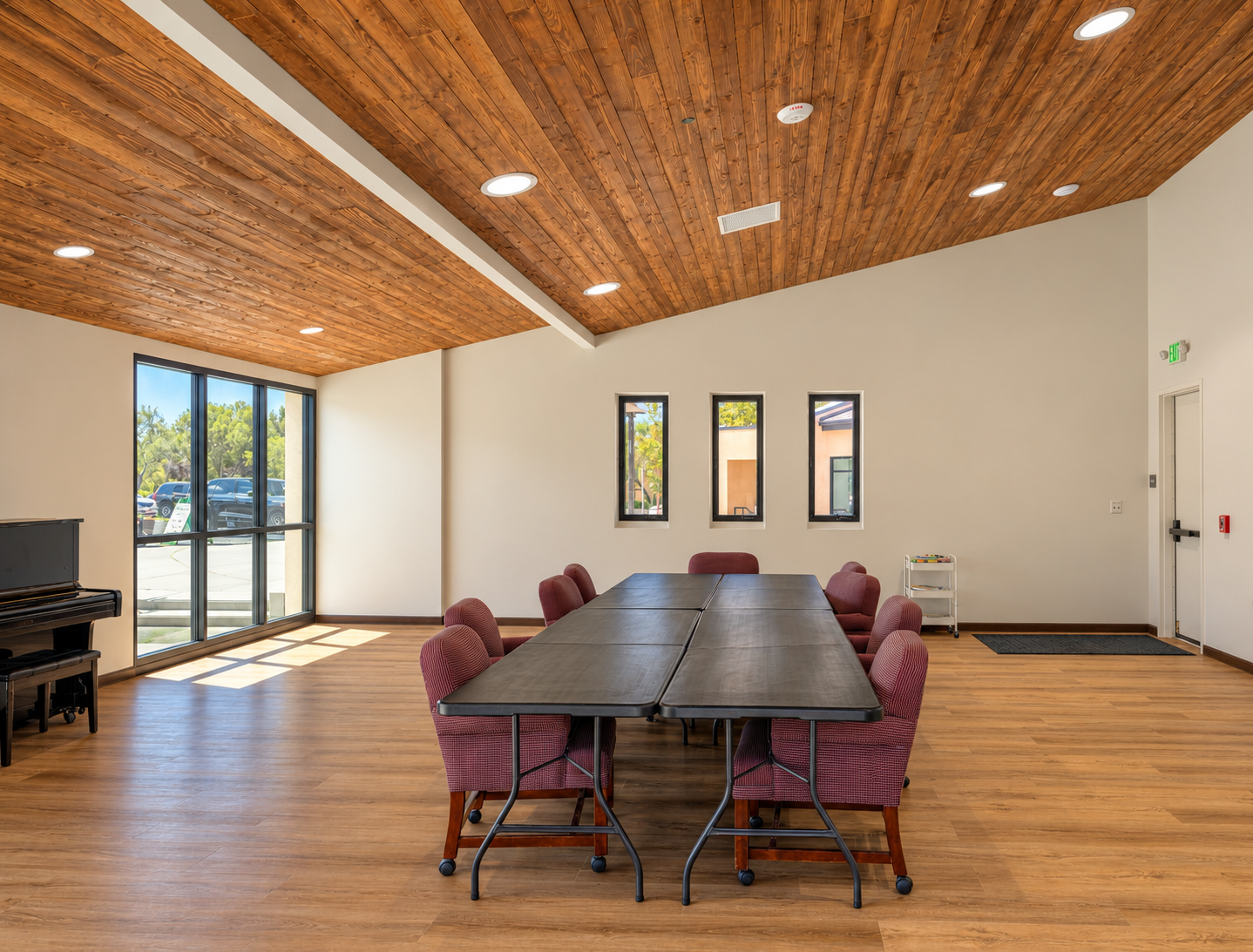 Sunlit warm wood meeting room.png