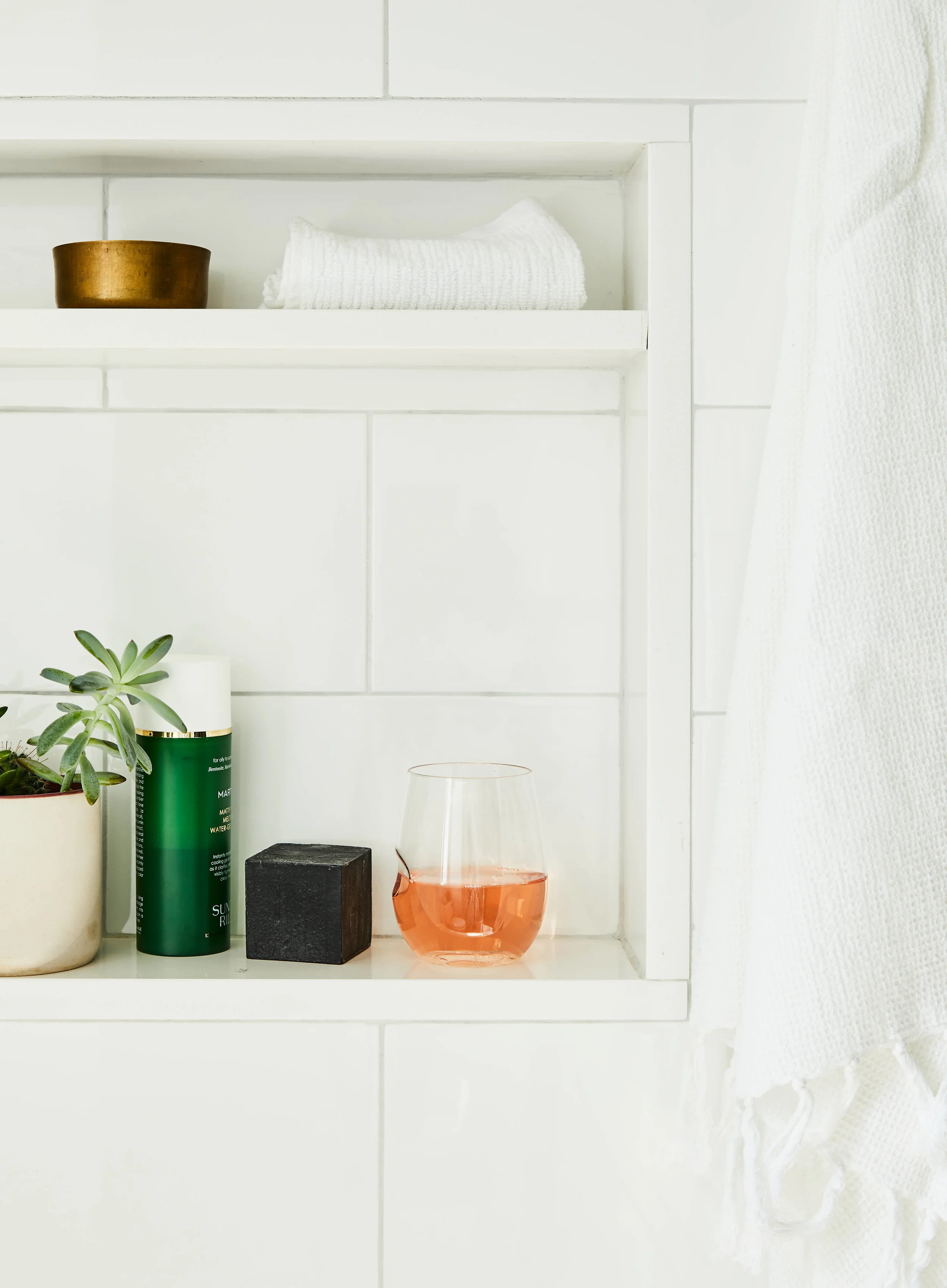 kate sears editorial nyc art director govino unbreakable wine glass rose orange wine succulent black soap bathroom white tile towel modern shower clean sunday riley skincare