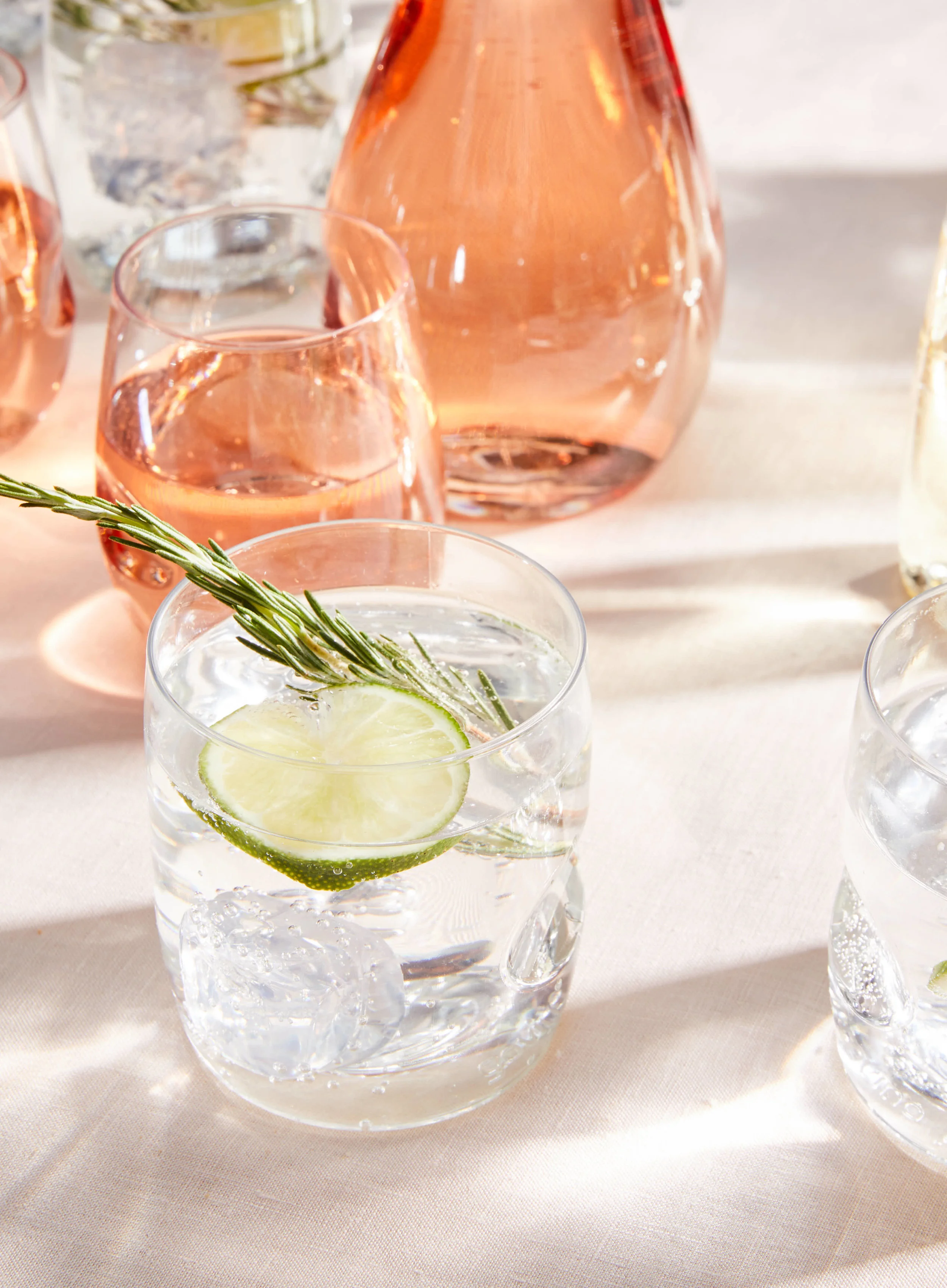 kate sears editorial nyc art director govino unbreakable wine glass decanter rosemary rose lime champagne brut sparkling light shadows event bar table