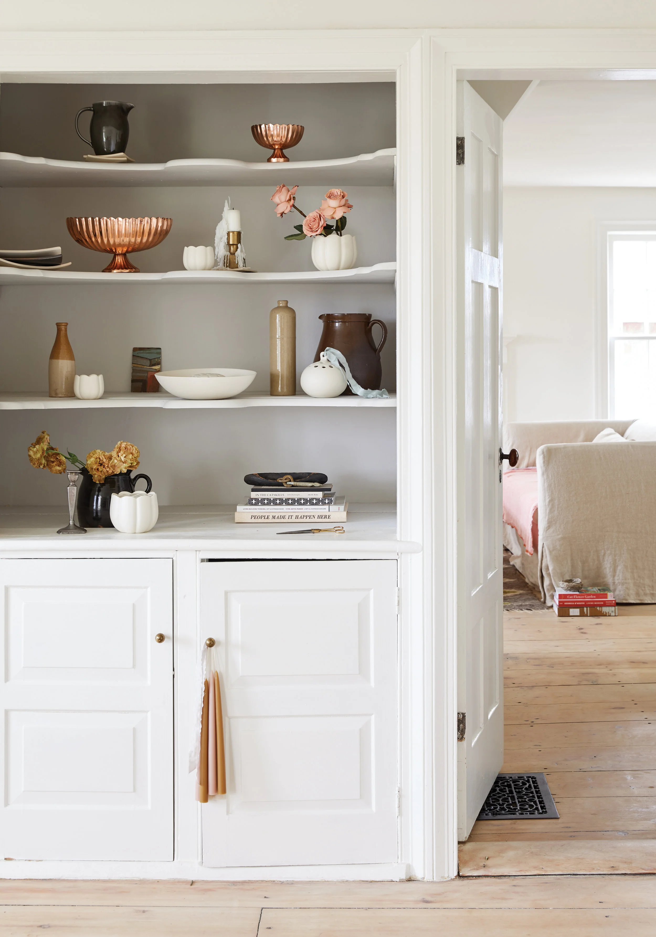kate sears built-ins sierra steifman nyc art director photographer lifestyle editorial the floral society white ceramic flower frog interiors living dining room shelving candles copper vase upstate