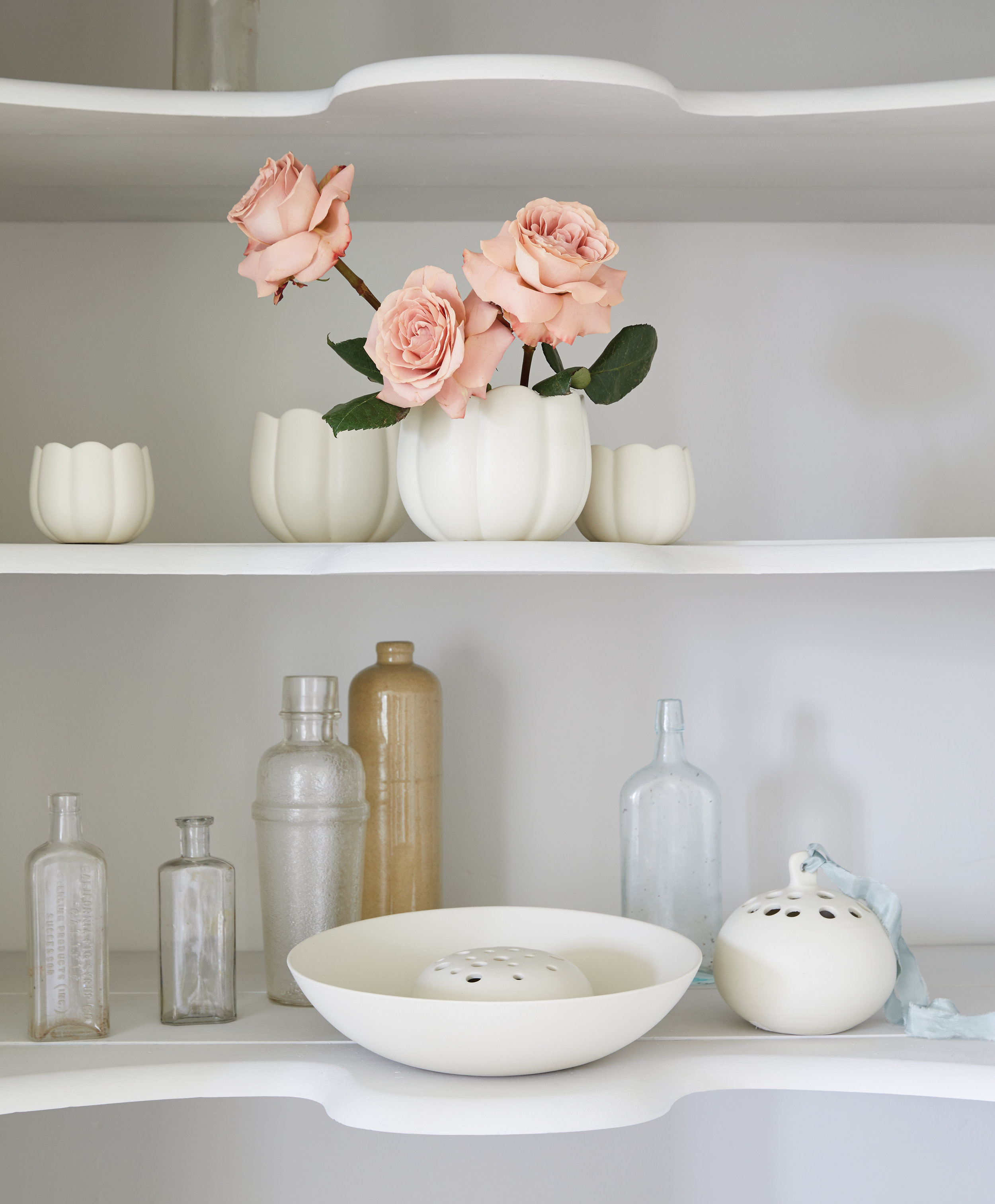 kate sears sierra steifman nyc art director photographer lifestyle editorial the floral society white ceramic flower frogs bowl design shelves pink roses blue ribbon home built-in cottage upstate 