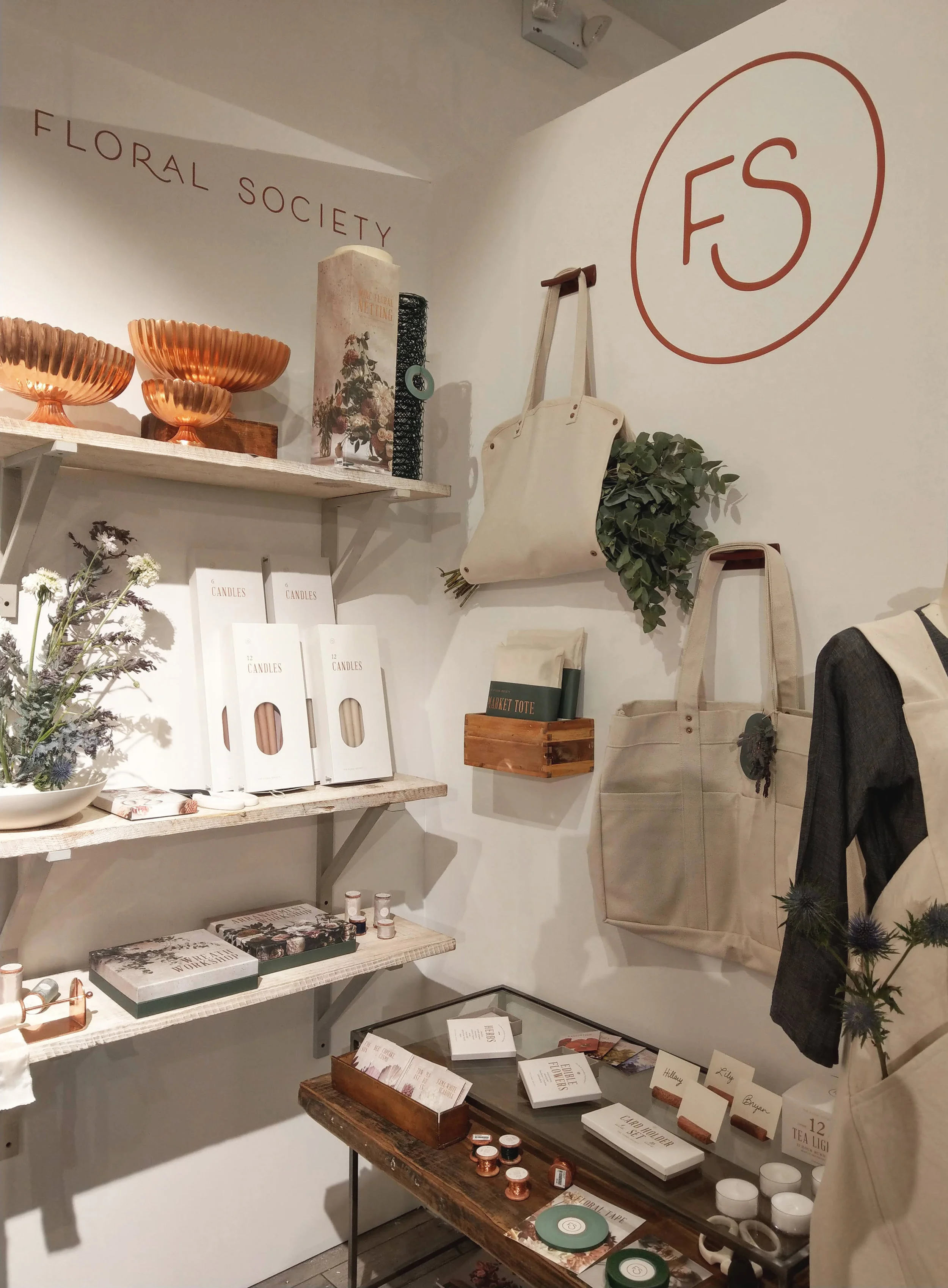 wholesale the floral society trade show collection shoppe object monogram logo packaging product candles tapers totes apron canvas copper vase