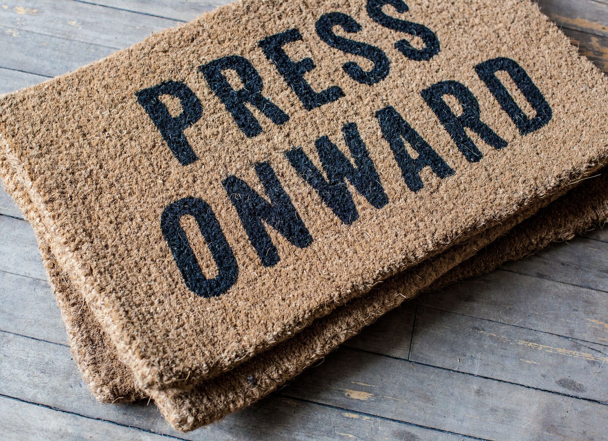 nyc graphic designer izola door mat press onward printed black text italic product home doormat gift porch