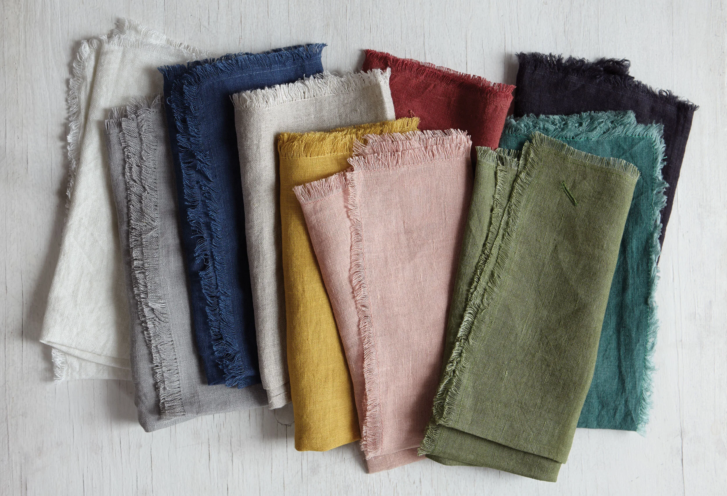 kate sears gift home aesthetic movement wholesale art director nyc sir/madam sirmadam linen fringe napkins white dove indigo natural salmon fern emerald black oxblood folded