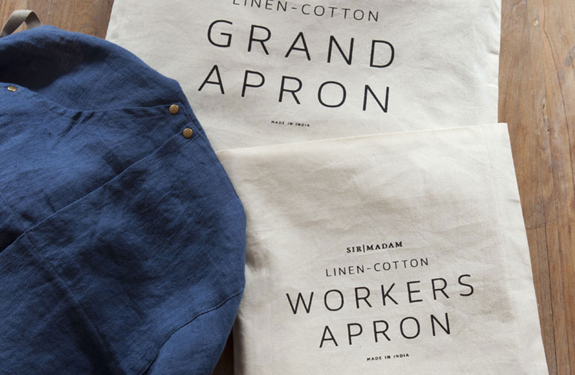 gift home aesthetic movement wholesale graphic designer nyc sir/madam sirmadam grand workshop kitchen garden apron linen cotton brass rivets indigo packaging pouch