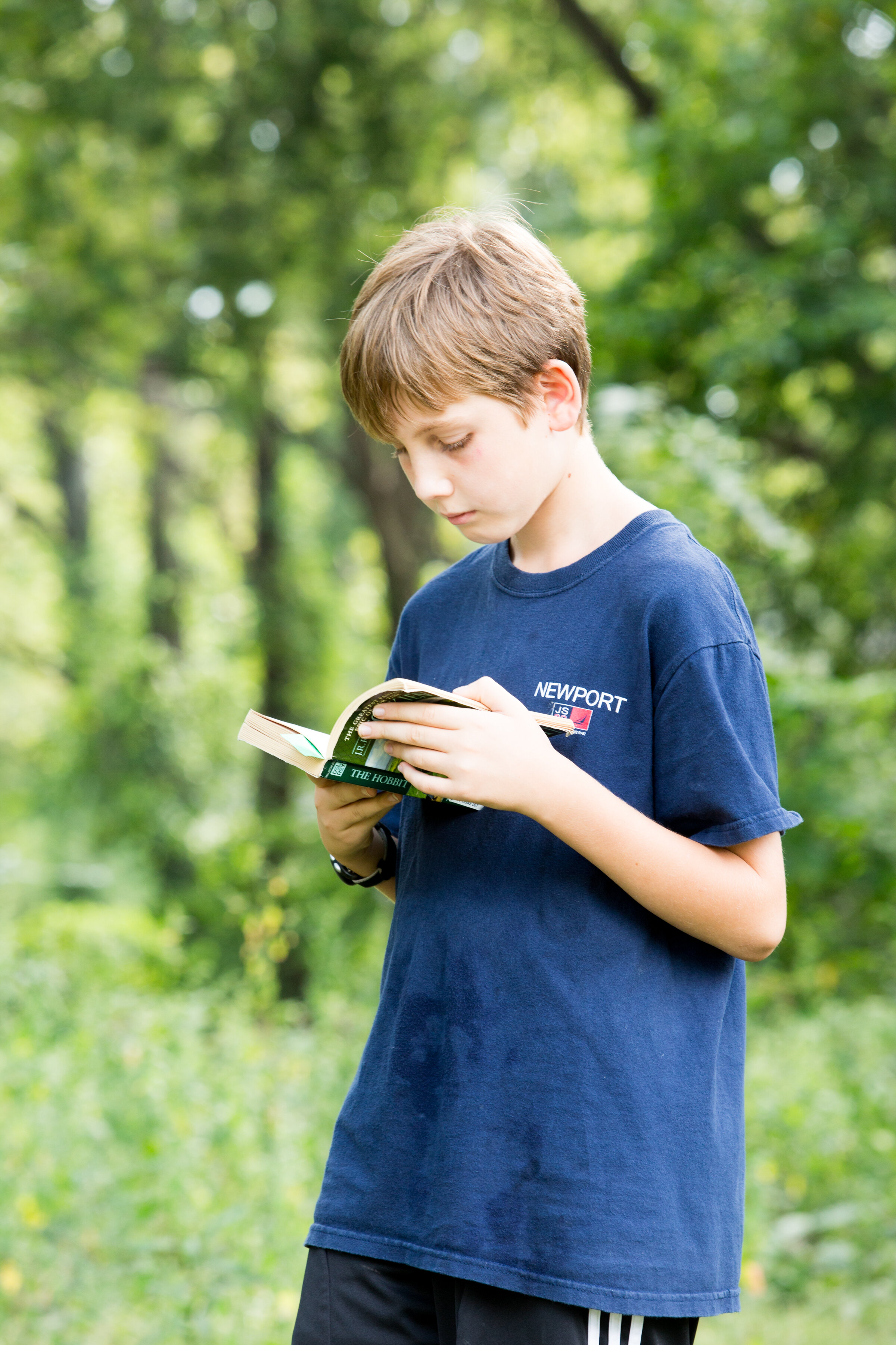 boy reading and walking outside.JPG