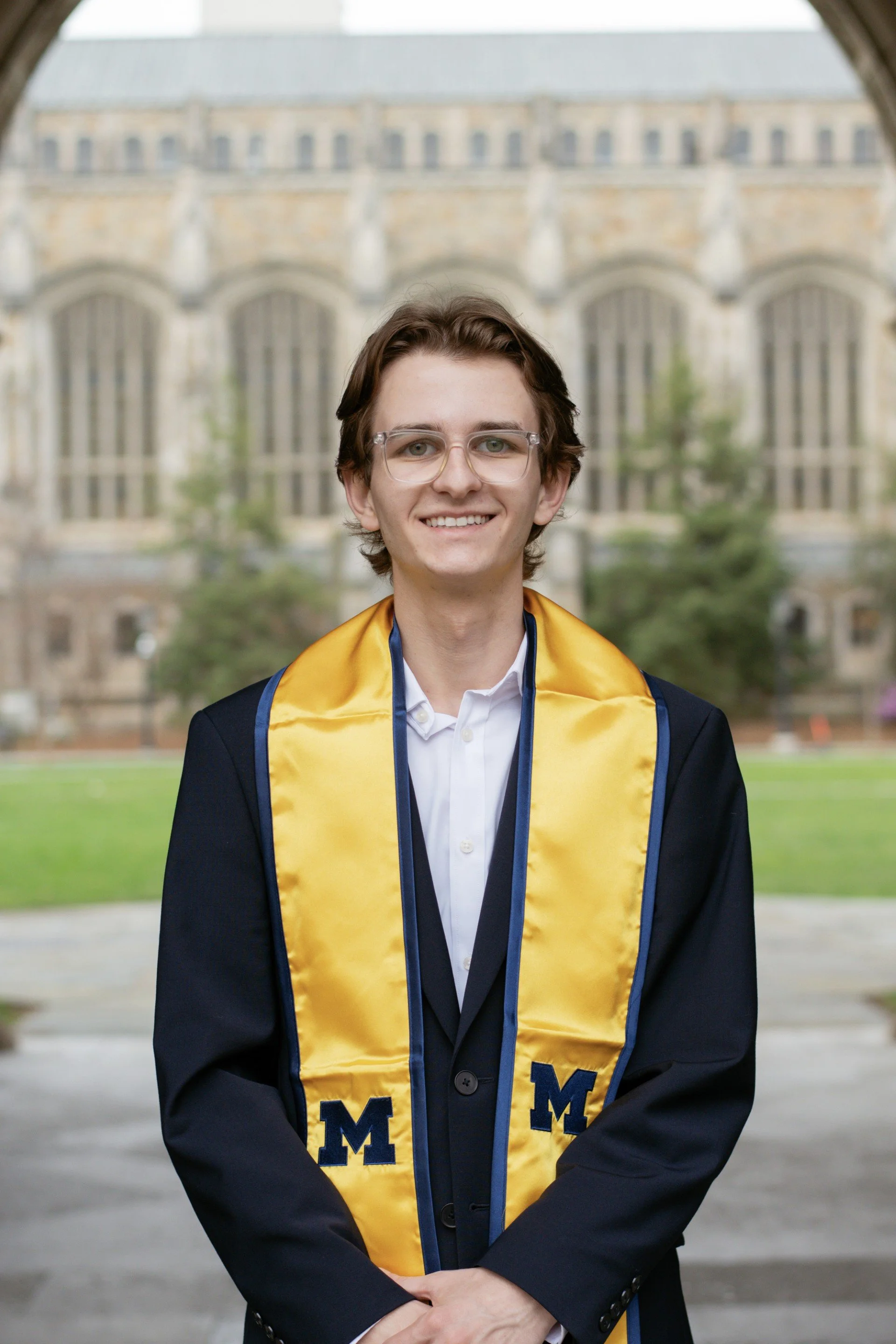 Ethan Goldiez headshot at graduation with a yellow stole around his shoulders