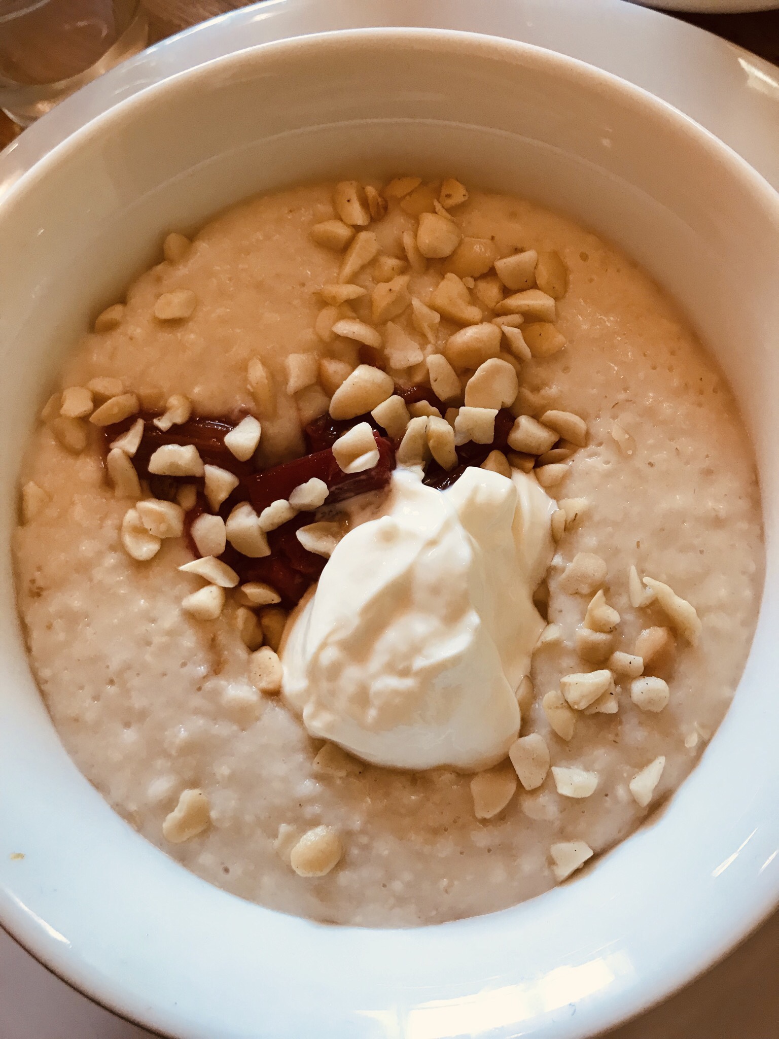 Creamy porridge topped with macadamias and greek yoghurt at Parc.
