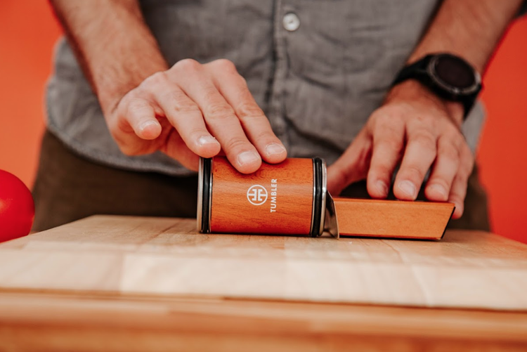 Tumbler knife sharpener in use