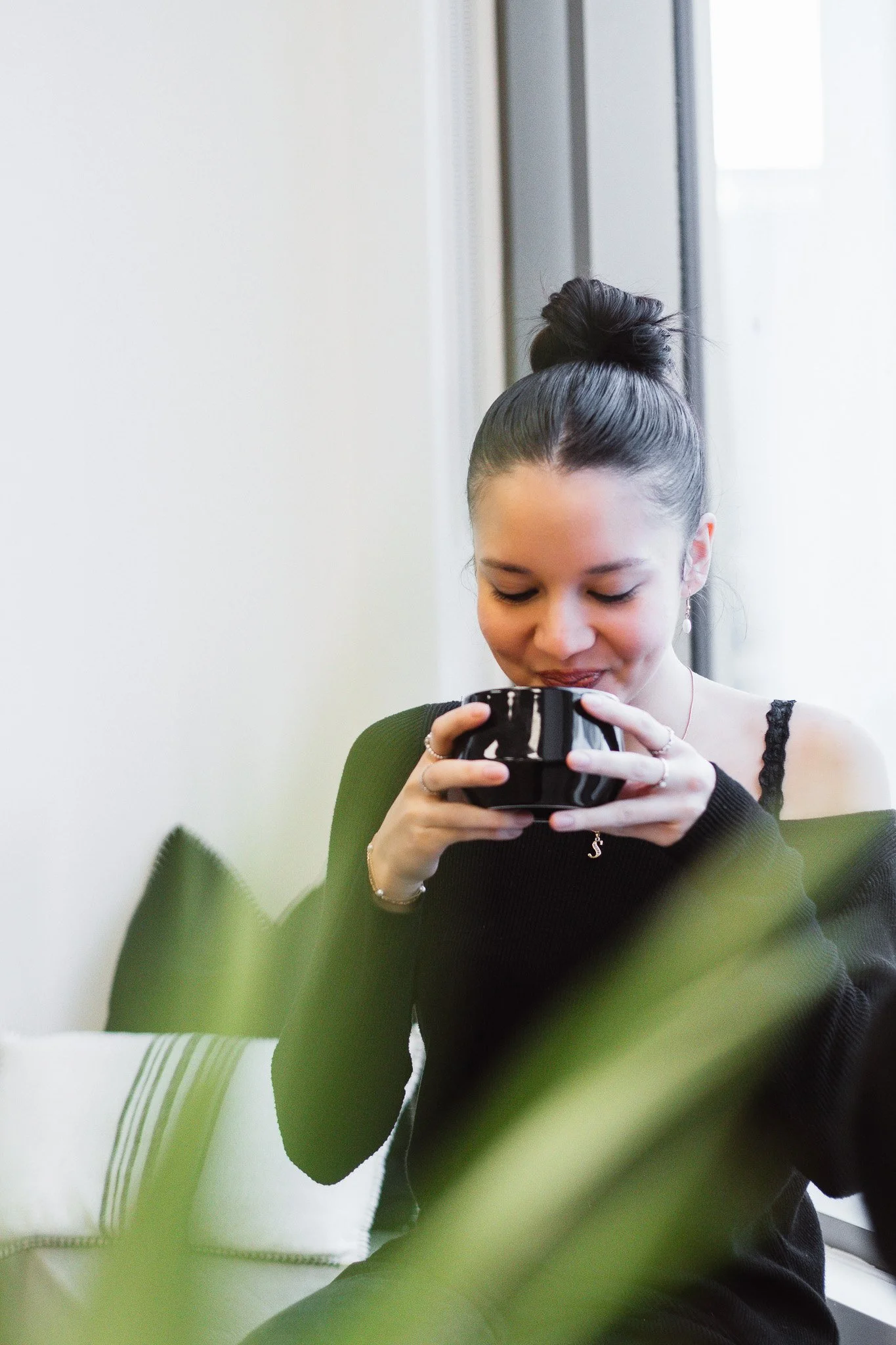 Student drinking at a café inside AIW student lounge and café area