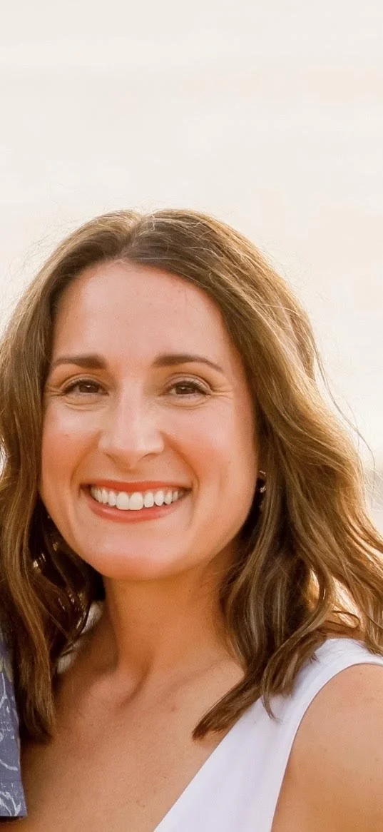 Photo of Mrs. Kathleen who has shoulder length brown hair, brown eyes, and a big smile. She's wearing a white tank.