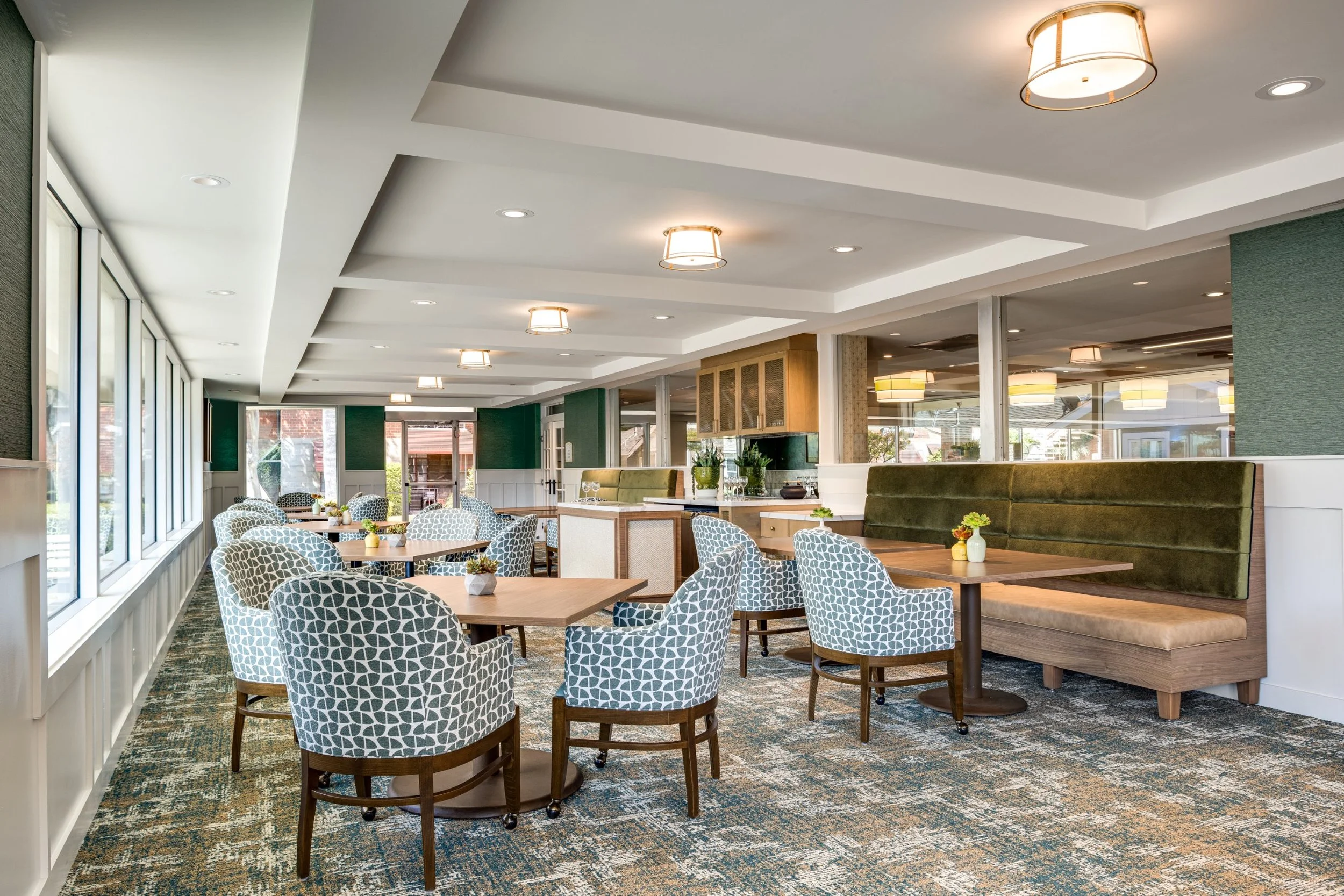 Café seating area with a banquette at Claremont Manor senior living community, photographed by a Los Angeles interior photographer