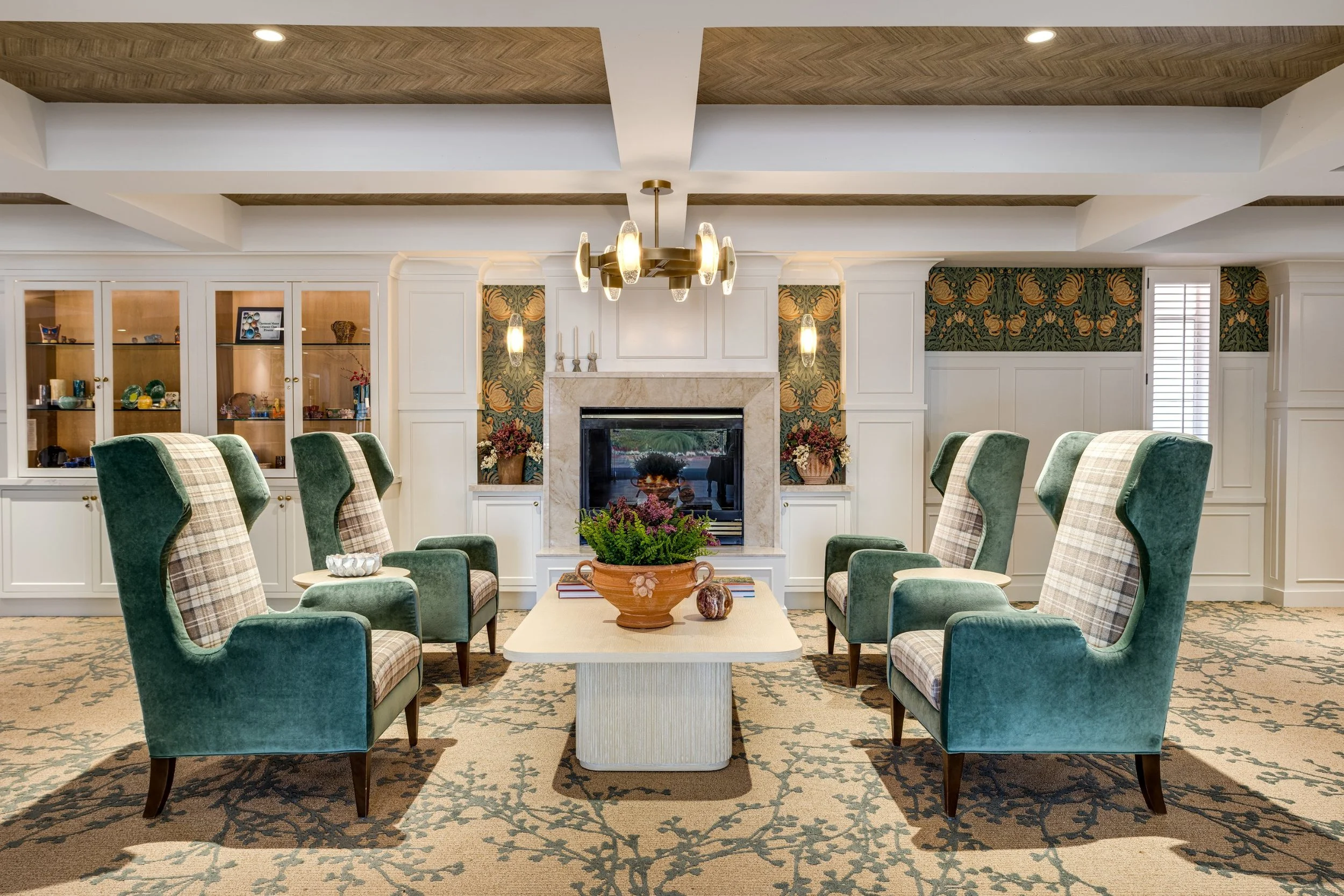 Lounge with green wingback chairs and a fireplace at Claremont Manor, photographed by a Los Angeles interior photographer