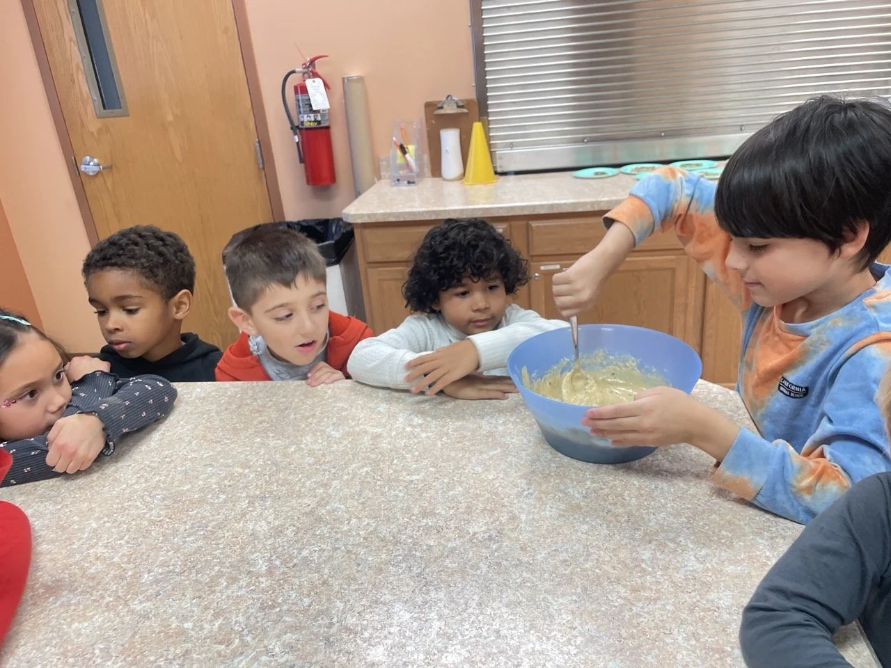 Spark Studio (Kindergarten+) learners cooking in the kitchen at Acton Academy
