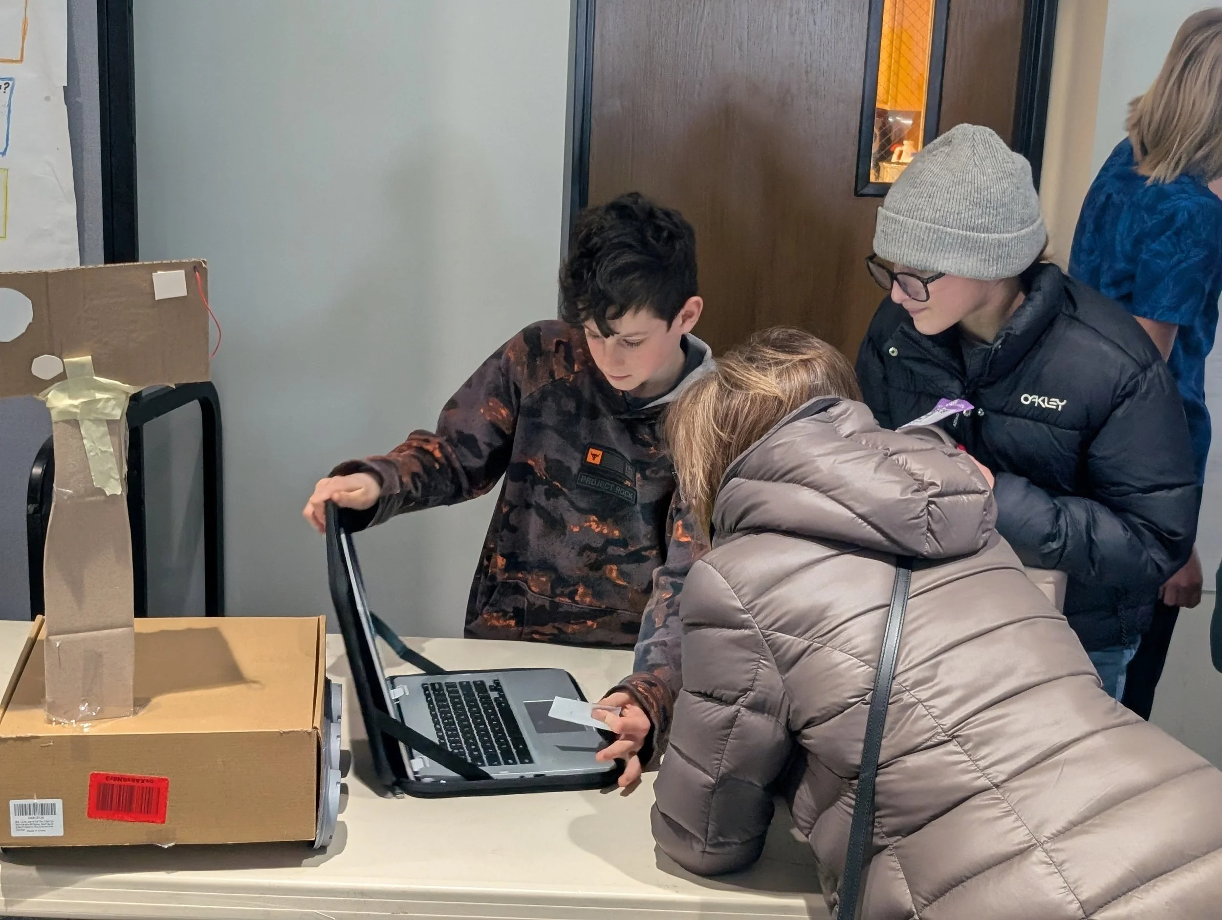 Learners testing AI project with a visitor