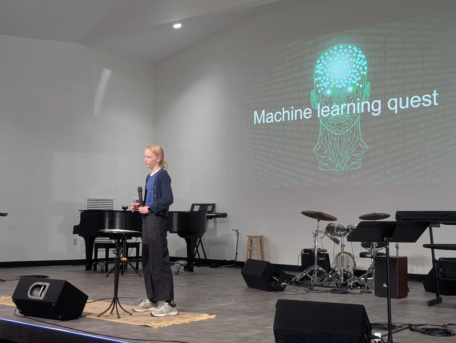 Learner presenting on stage