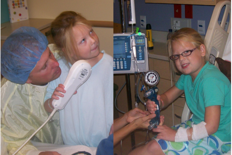 A young girl in a hospital bed with an IV in her arm and wearing glasses, smiling at the camera, while a medical professional, also in a hospital gown and cap, holds her hand. Another young girl, sitting in a hospital bed with an IV in her arm, is holding a thermometer and looking at a man who is possibly a healthcare worker or relative, in a hospital room.