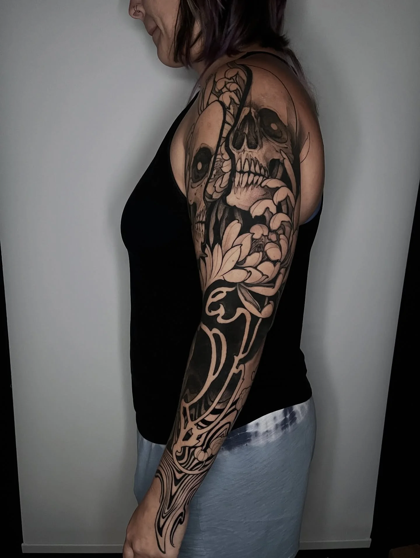 Getting closer to finishing up this sleeve! Having a blast on this, why not show some more wip shots! Most upper arm stuff is healed, middle circle design is not by me - more to come soon! @glasshouse.fl 
.
.
.
.
#skulltattoo #blackandgreytattoo #flo