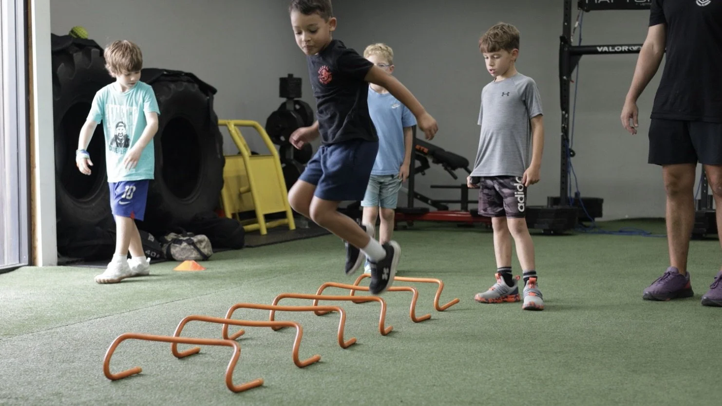 Young athlete performing speed and agility hurdle drills during Perform24 Project Speed training in Tampa, Florida.