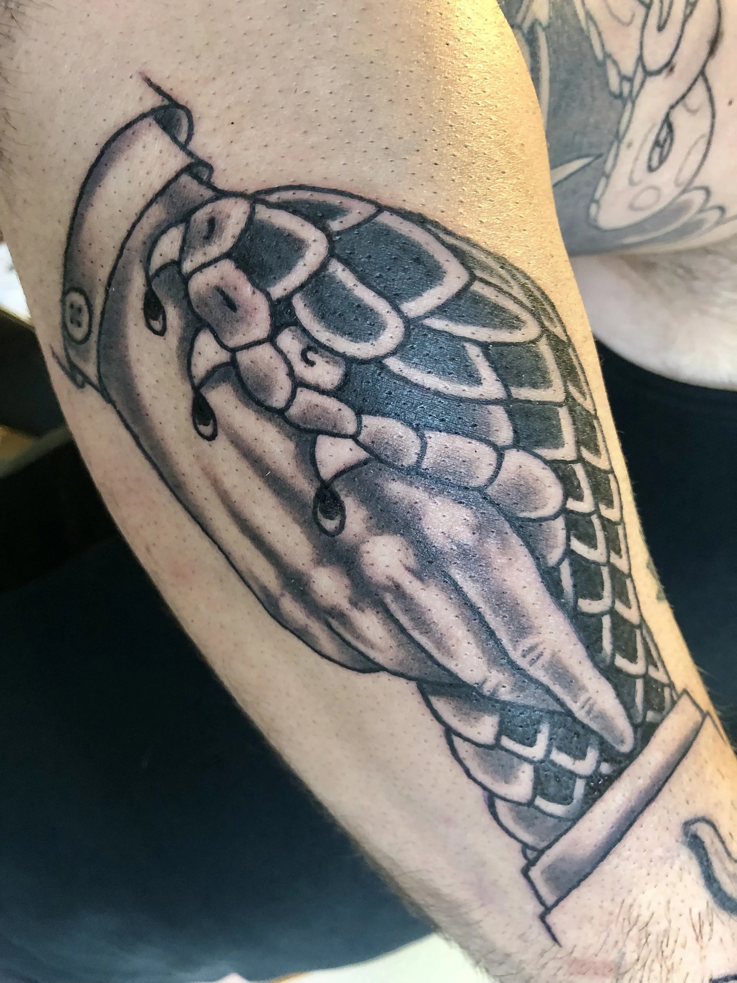 Black and grey snack handshake American Traditional tattoo