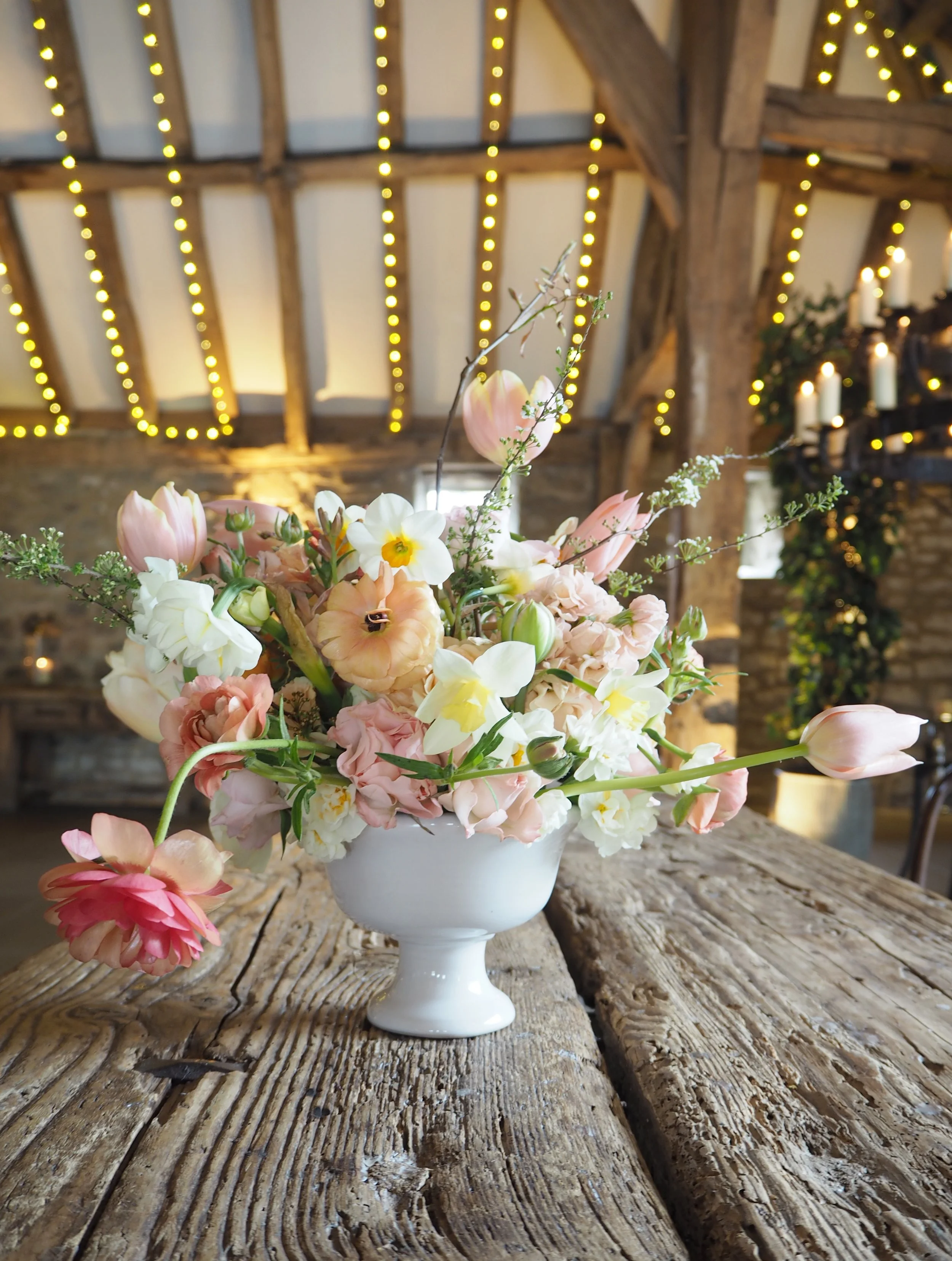 white footed bowl from The Dish Girls full of spring flowers in pinks, butter yellow, whites and corals, at the Tithe Barn, Bolton Abbey Yorkshire 