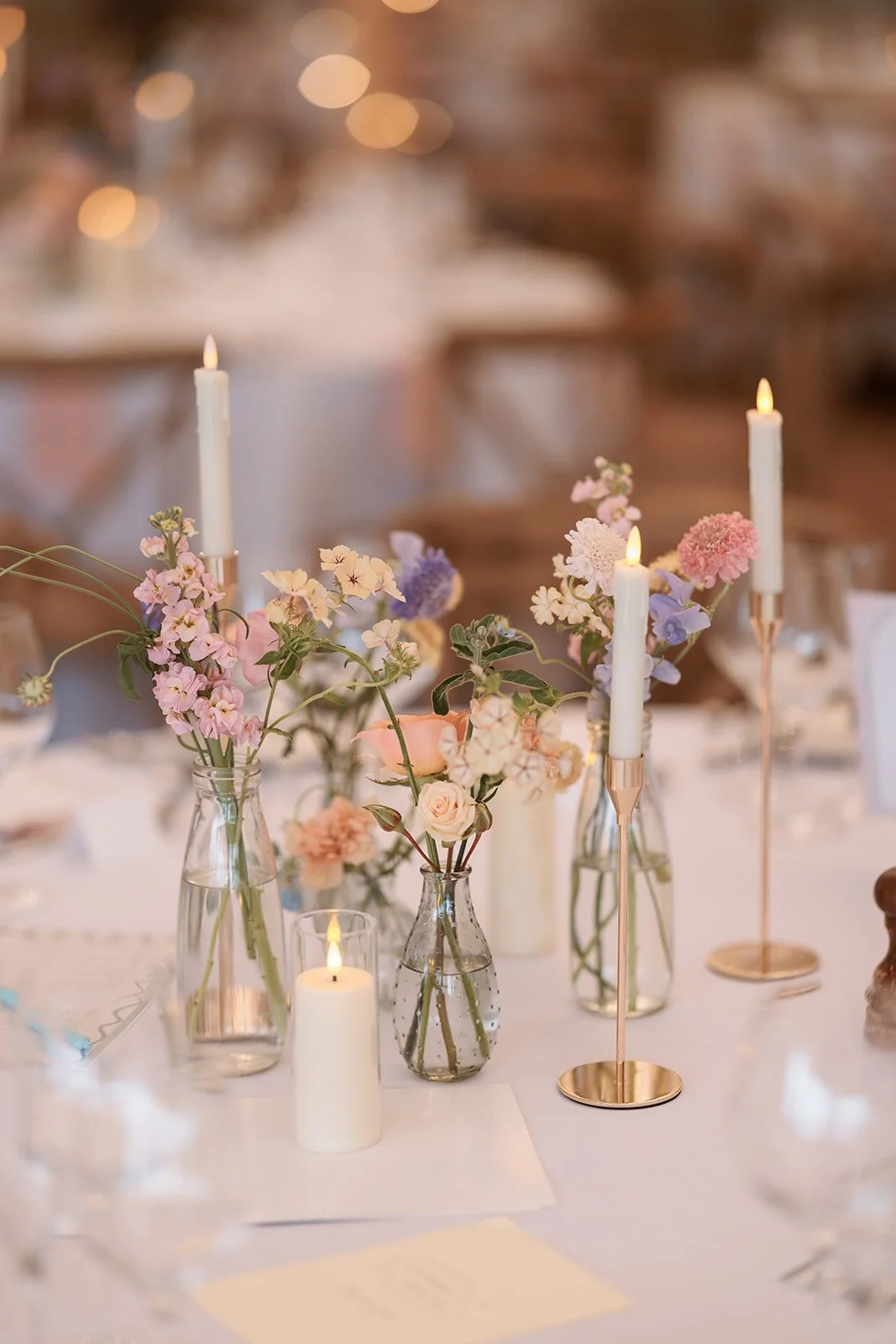 pastel coloured summer flowers in bud vases at Middleton Lodge, North Yorkshire 