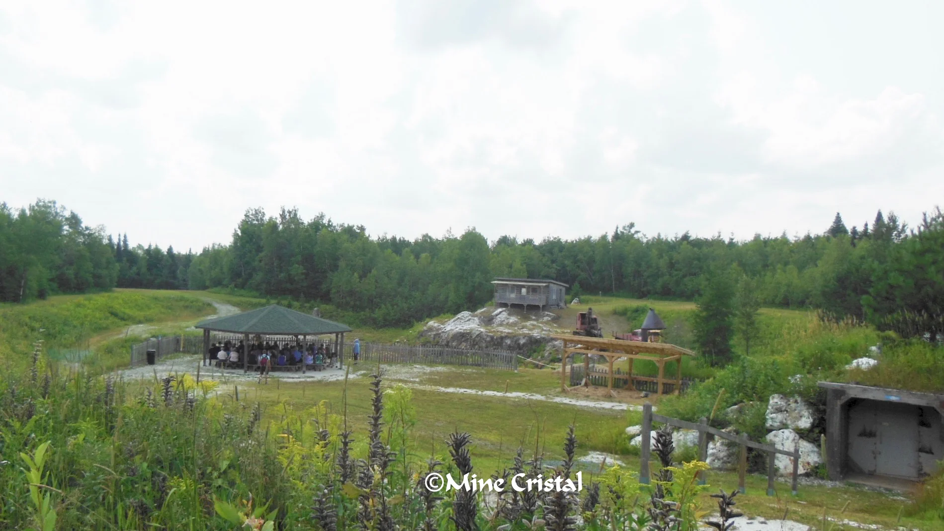 Participants sat under a gazebo at the crystal mine, while the guide told them all about crystals.