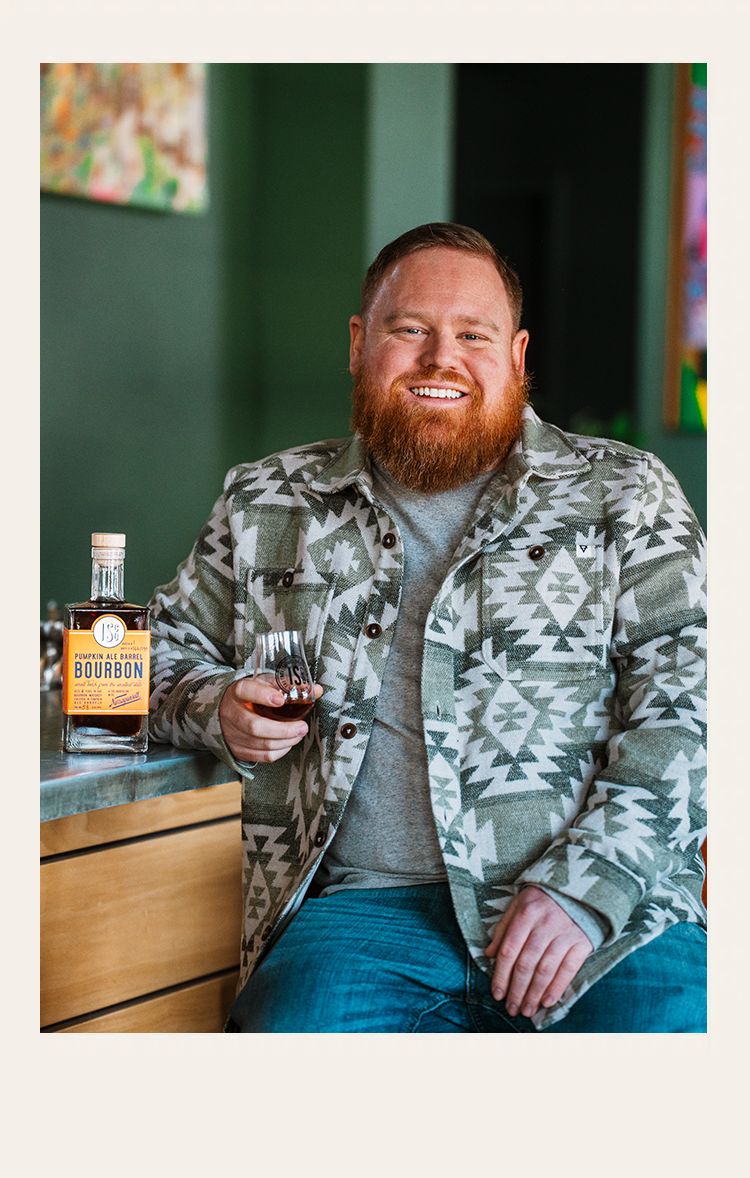 daniel safley seated at ISCO bar with pumpkin ale barrel bourbon