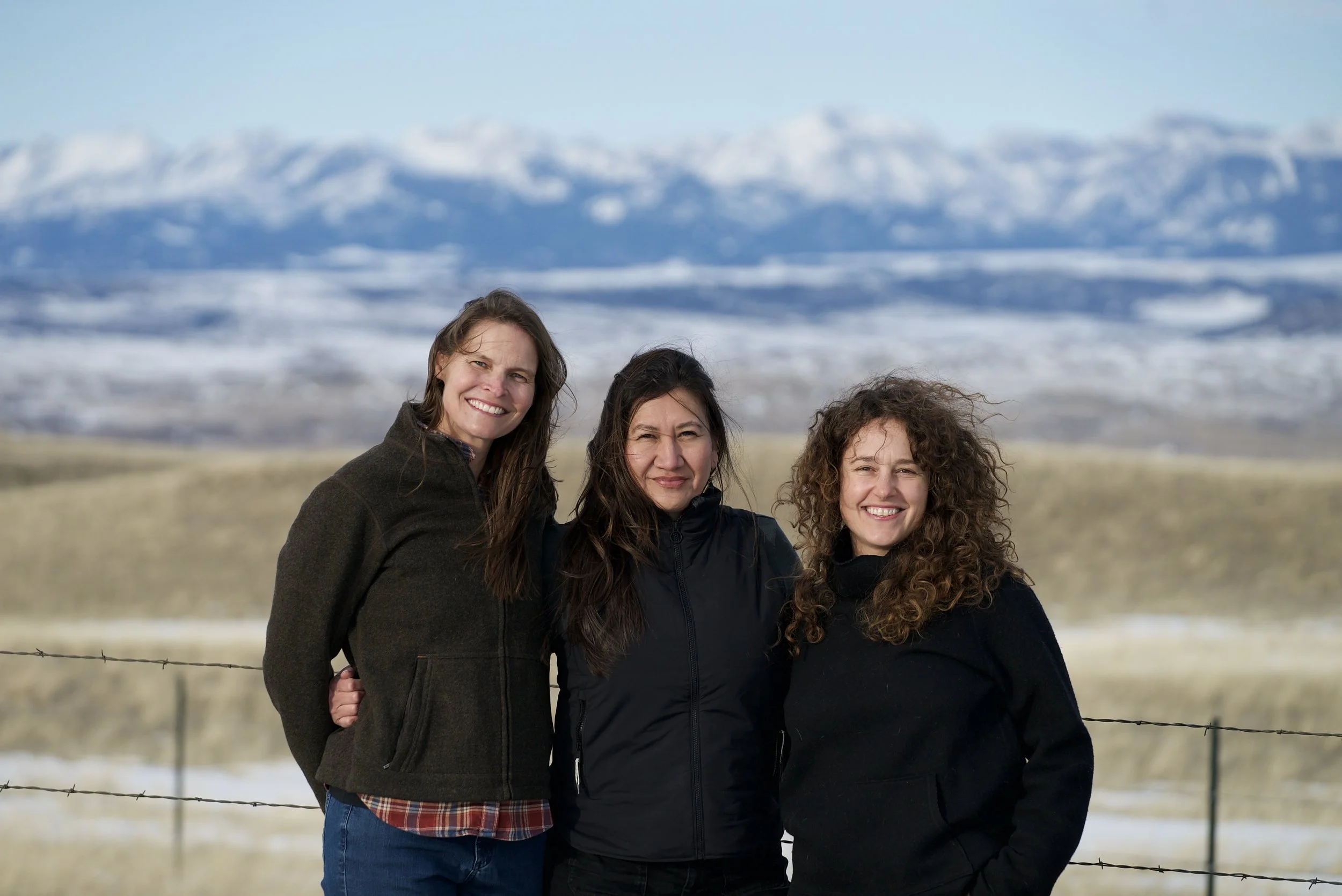 Crazy Mountains Oral History Project Team, Erica Lighthiser (PCEC), Francine Spang-Willis (AFWC), and Sarah Stands (PCEC) stand in front of the Crazy Mountains Range.