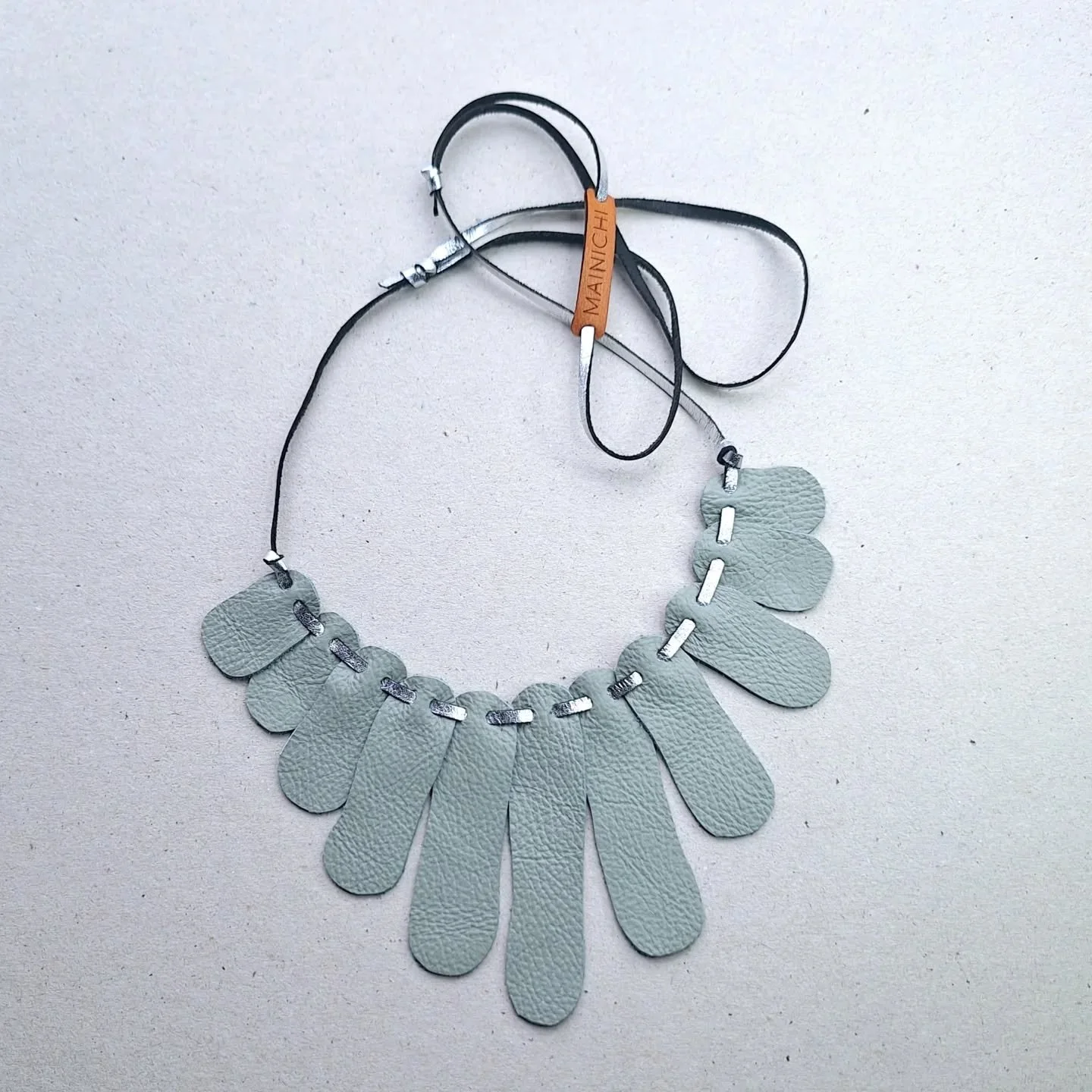 Recycled upholstery leather was cut by hand to shape the Sensu necklace. Lightweight and versatile, wear your own sustainable story. A selection of colours available on the website. Always in limited editions, because we work with salvaged materials!