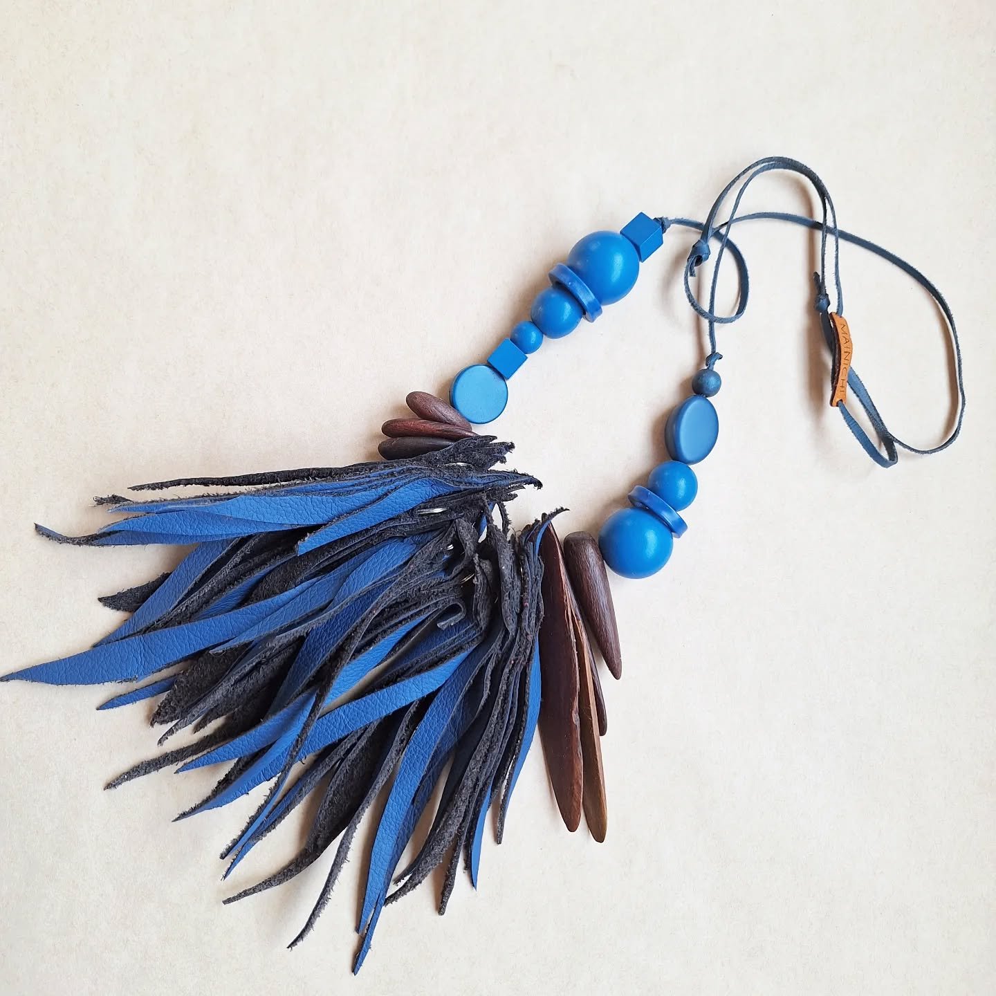 Feather necklace in blue by MAINICHI.

Sometimes it's really hard to part with the things I make, I am so drawn to the delight of a particular combination of materials, colours amd textures.

Blue is one of my favourite colours, and this one will be 
