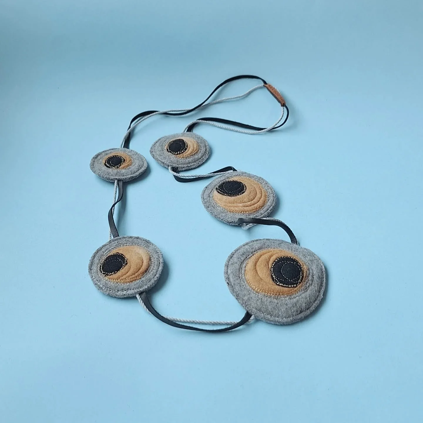 Materials with a story.

Repurposed wool blanket offcuts and upholstery felt on Australian leather.

Shinzo necklace by MAINICHI

#handmadeinaustralia #SustainableJewellery #mainichimade #madeinballarat #recycledtextile