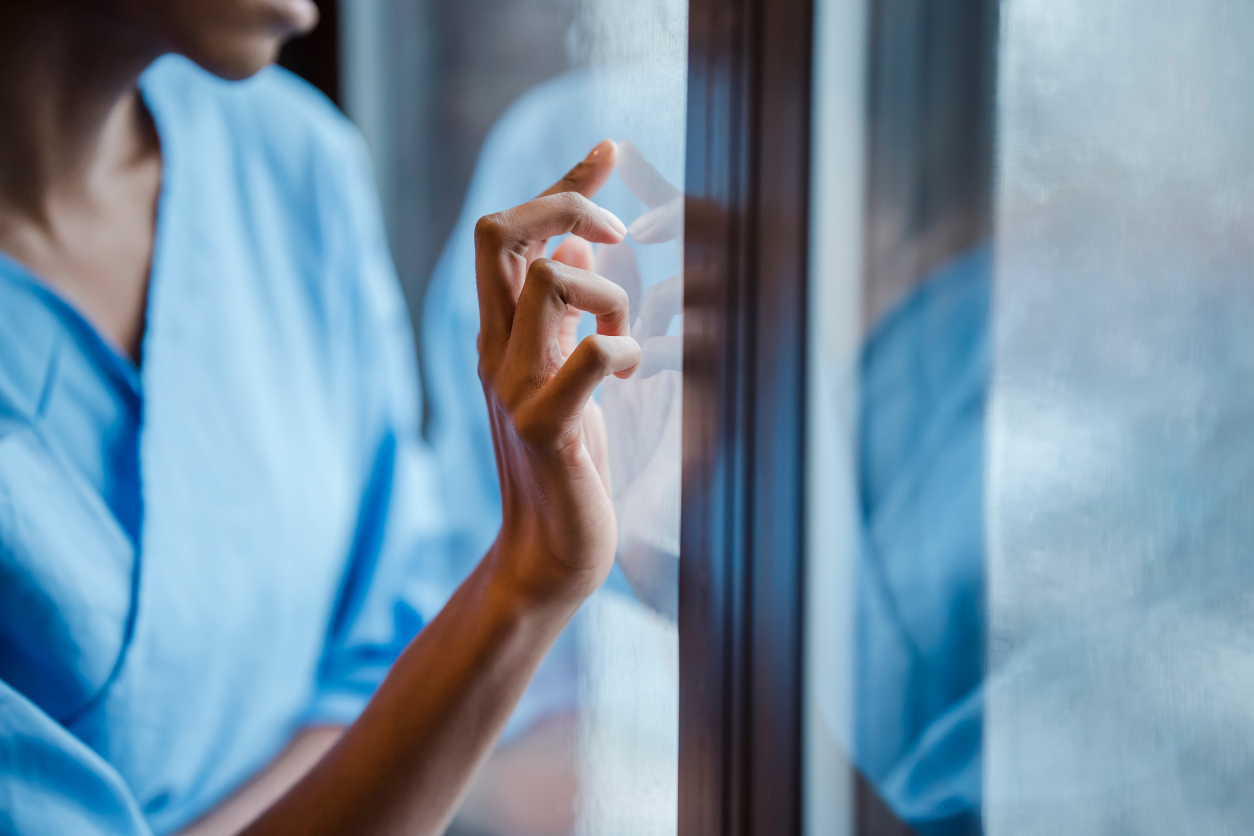 woman looking out window