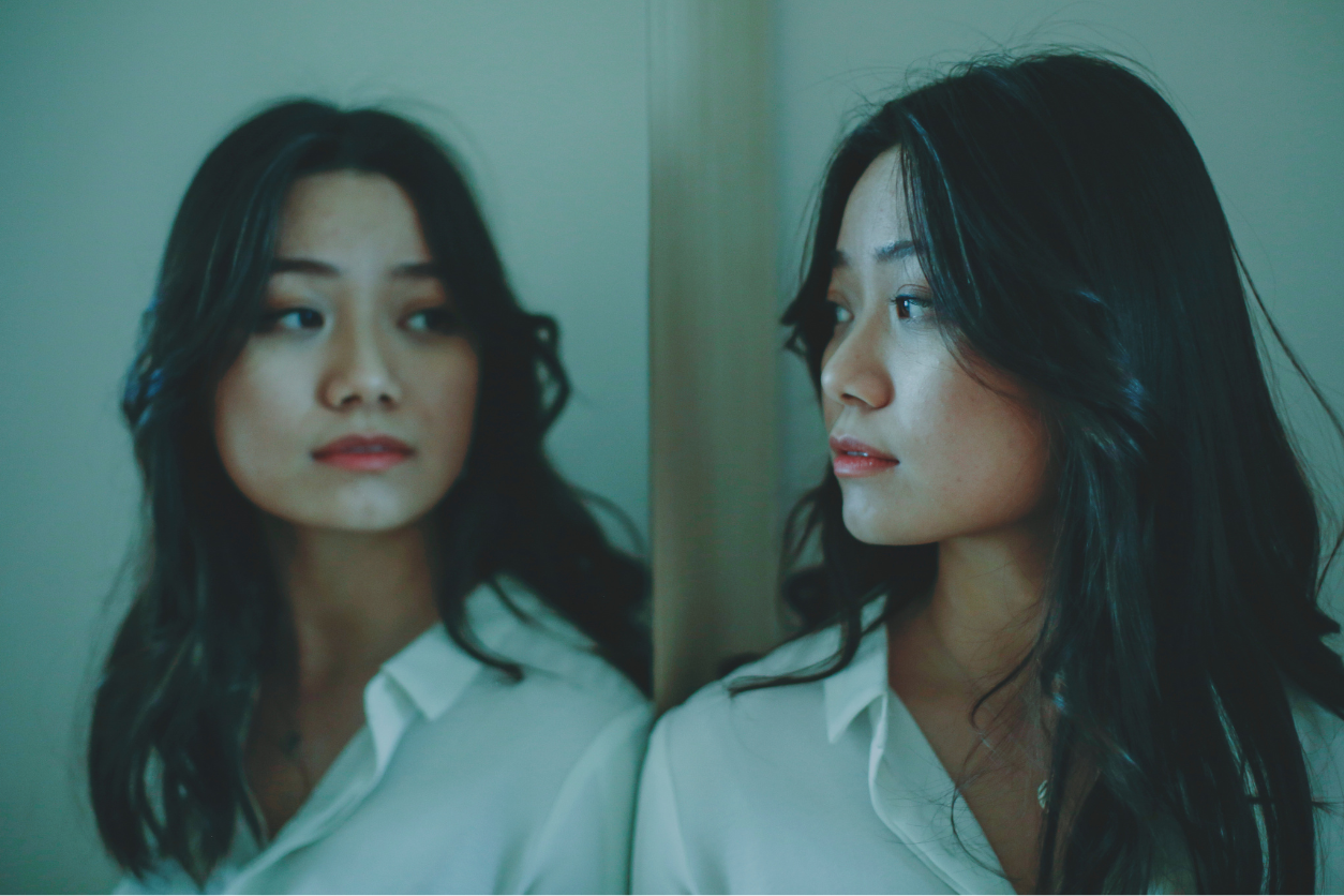 woman looking in mirror