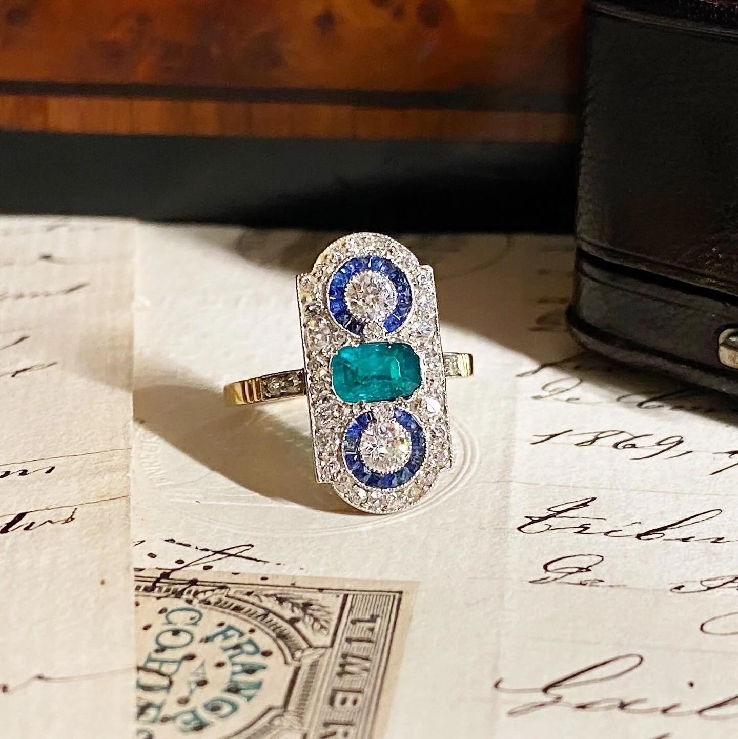 Art deco ring in gold, platinum, emerald, sapphire and diamonds