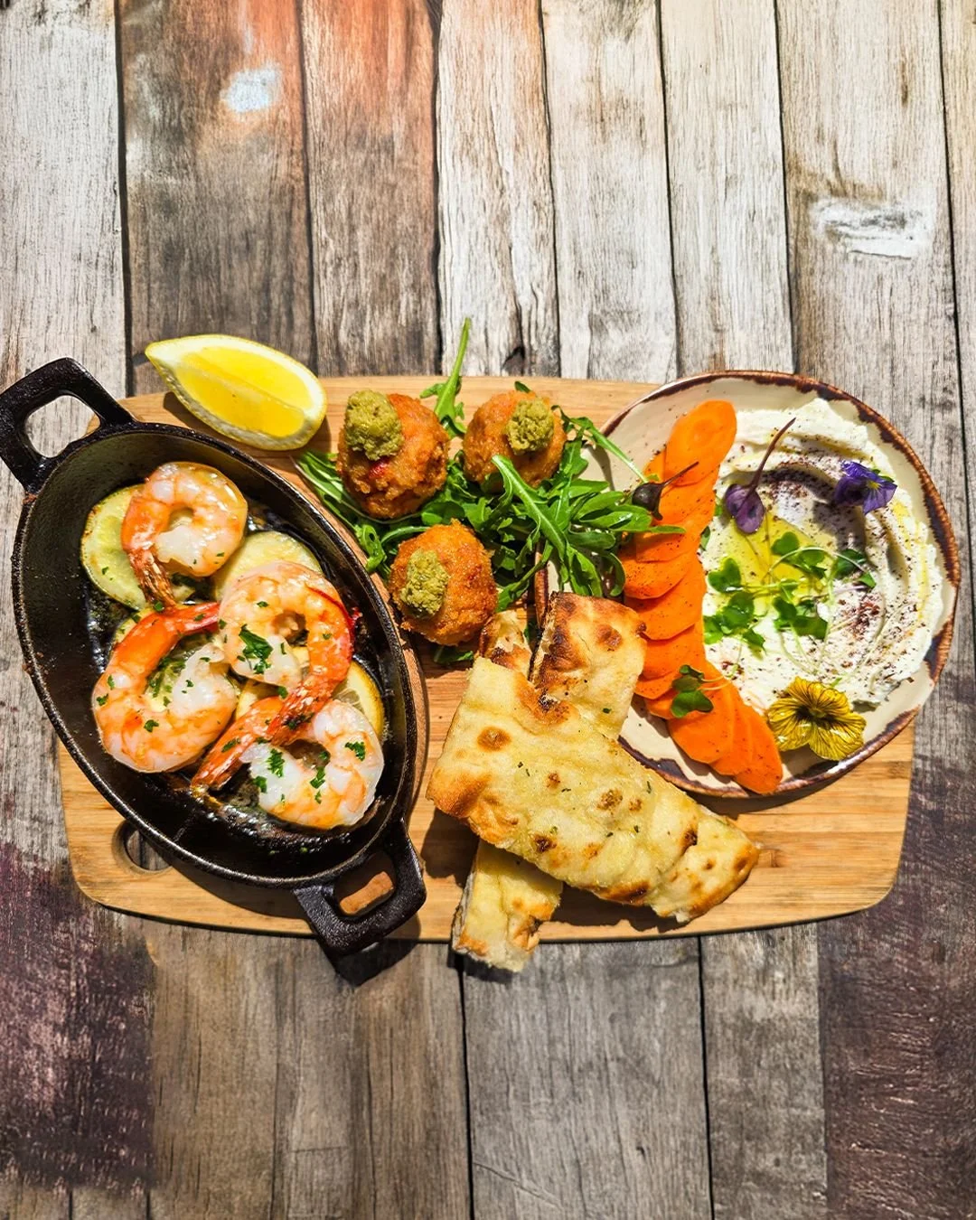 Golden bites and sizzling pans by the river.

Carbonara Croquettes packed with creamy carbonara flavour,
and Sizzling Garlic Prawns with chilli, lemon and rosemary flatbread. 

Sit back, relax and enjoy the summer breeze.