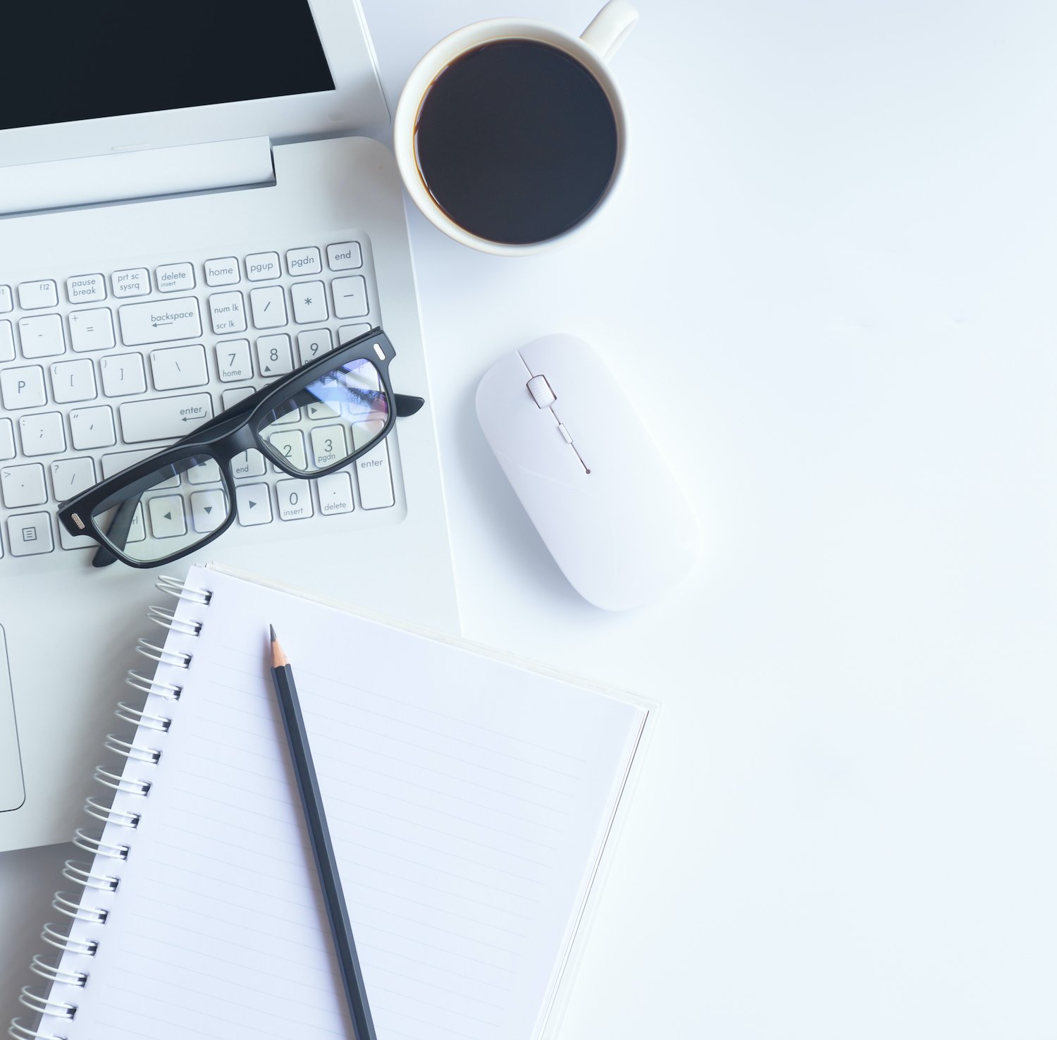 _White-desk-office-with-laptop,-smartphone-and-other-supplies-with-cup-of-coffee.-Top-view-with-copy-space-for-input-the-text.-Designer-workspace-on-desk-top,-view-with-essential-elements-on-flat-lay.-956234478_3869x2579.jpeg