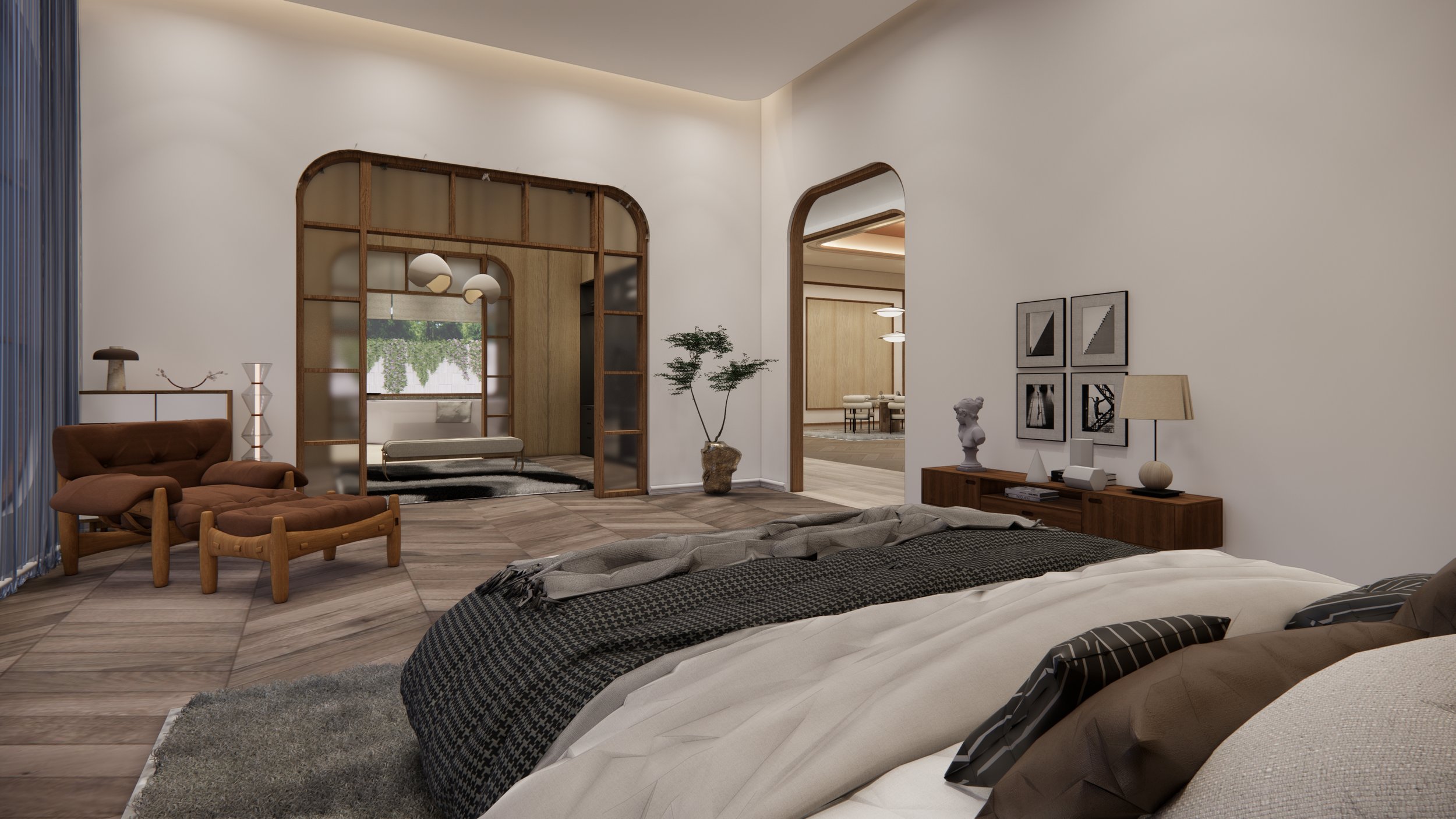 Modern bedroom with a large bed, black and white bedding, a wooden side table with a lamp and artwork, a potted plant, a cozy sitting area with a brown chair and footstool, and a decorative partition with a mirror in the background.
