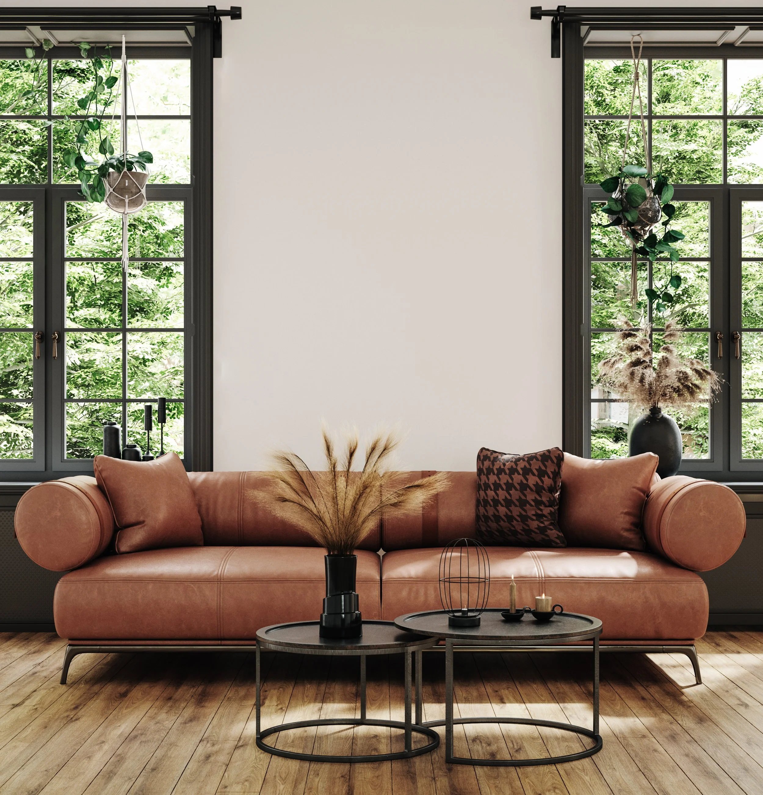 Living room with pink sofa, black coffee tables, decorative candles, and plants. Two large windows with black frames and greenery outside.