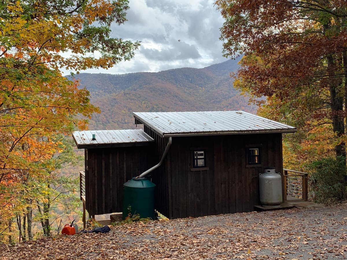  Escape the every day with this off the grid cabin located near the Pisgah National Forest featuring an outdoor shower, fire pit, and porta potty with a mountain view.    Typical starting price: $139    Location: Candler, North Carolina     Sleeps: 2