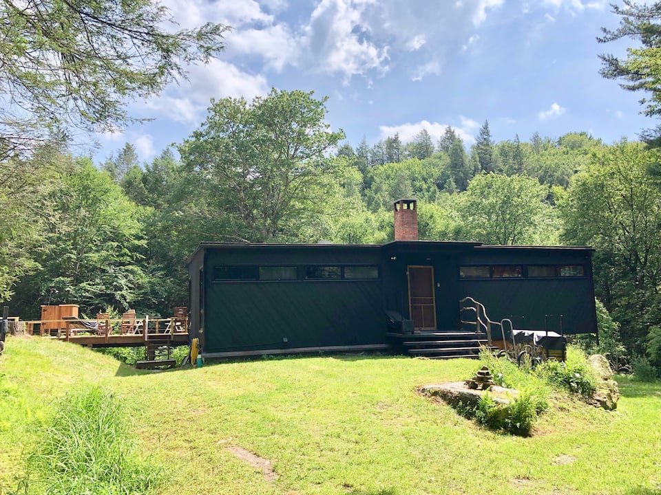 Enjoy a  mid-century modern stay  tucked in the woods for your next getaway! This house comes complete with an indoor fireplace, creek, and 12 acres of private land for your dogs to explore.   Typical starting price: $314    Location: Claryville, Ne