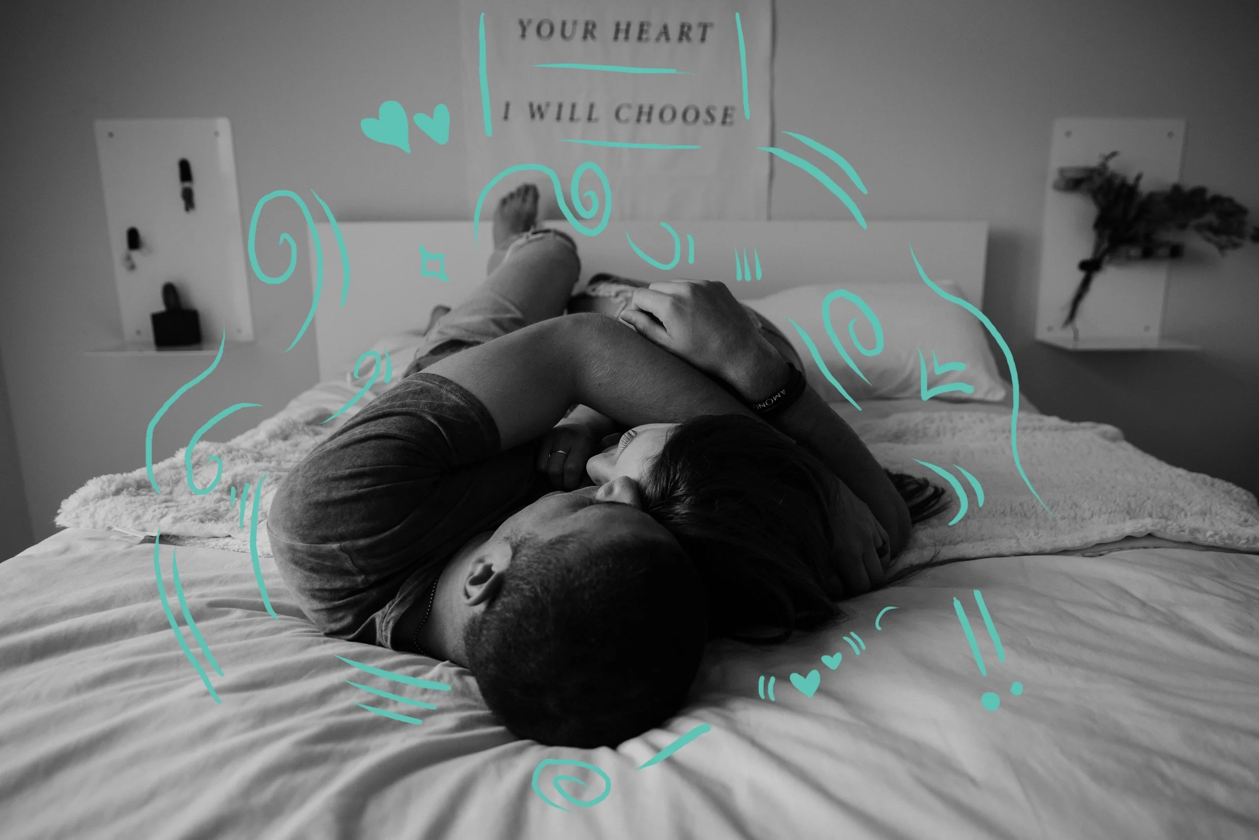 Heterosexual couple cuddling on bed