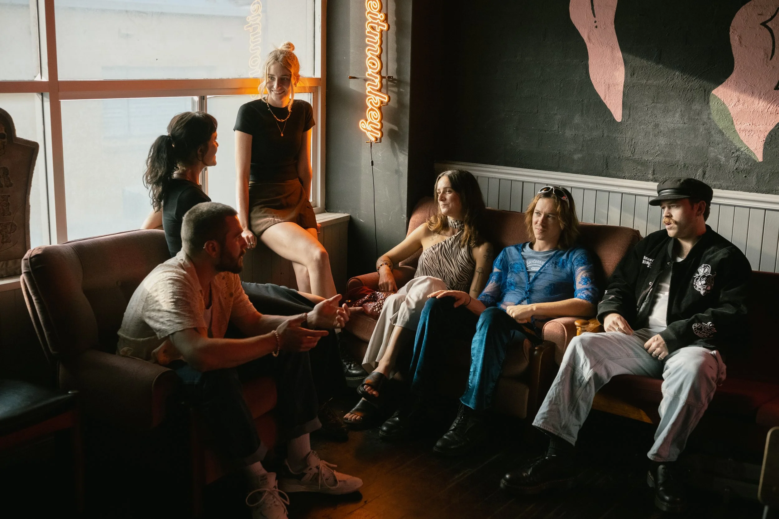 friends on lounge talking with engaged facial expressions.jpg