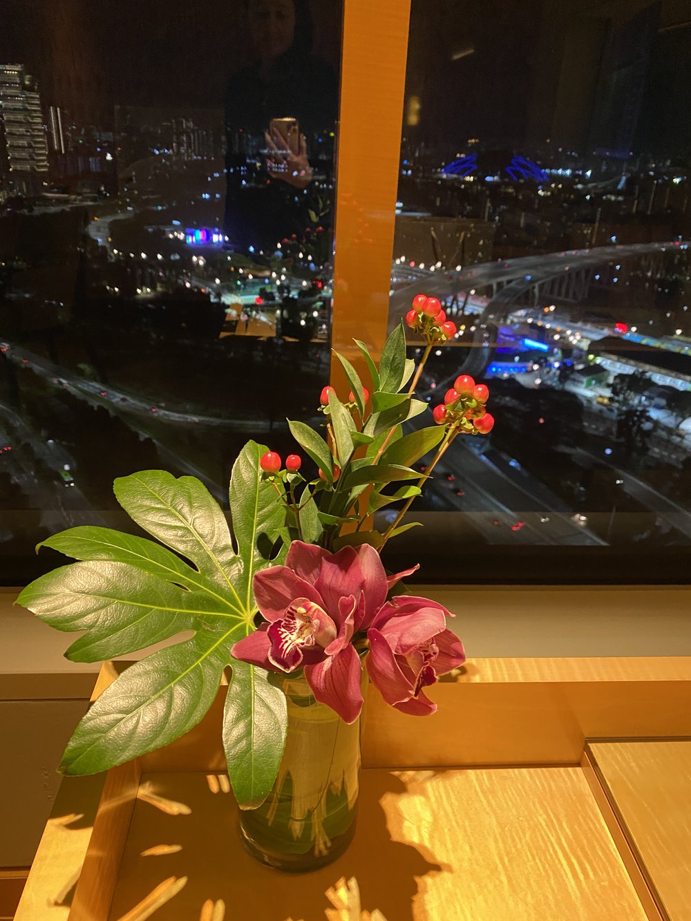 Fresh flowers looking out at night view from room.JPG