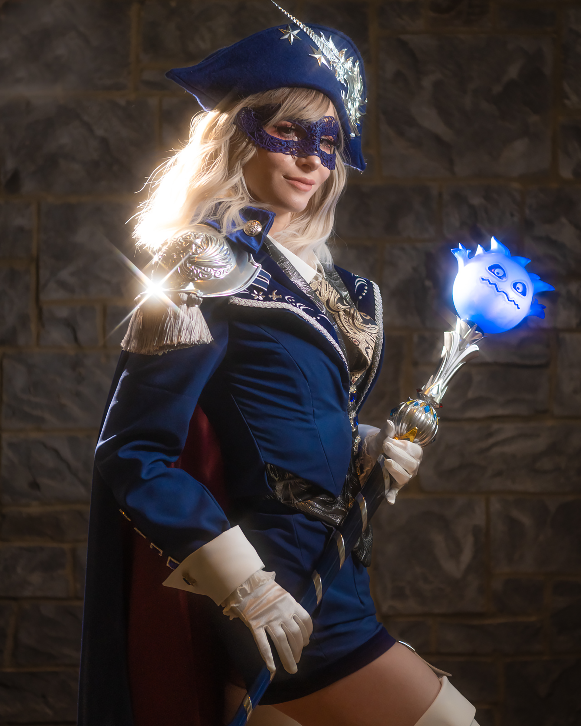 Bindi Smalls in a blue fantasy mage cosplay with an illuminated character prop.