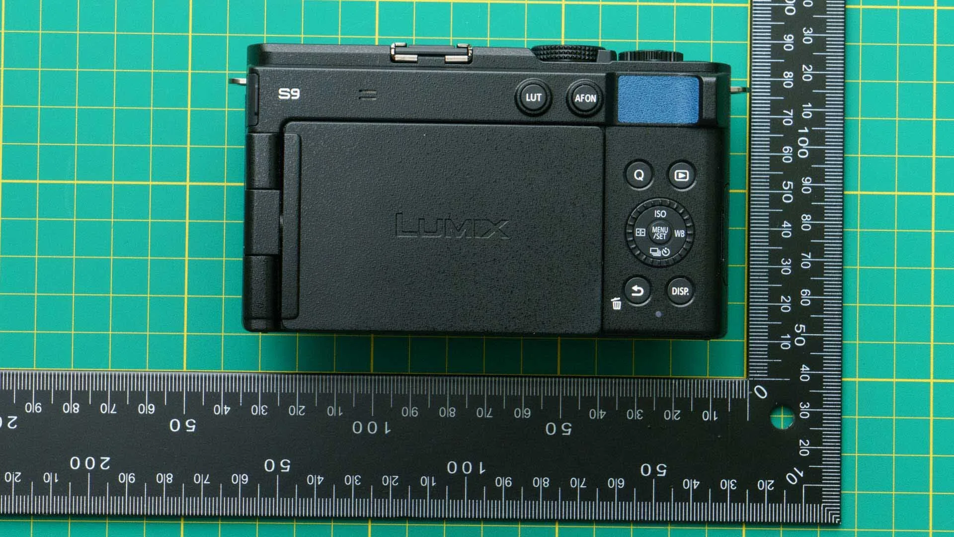The thumb rest to the right of the blue area on the back of this Panasonic S9 is small but fairly pronounced from the body.