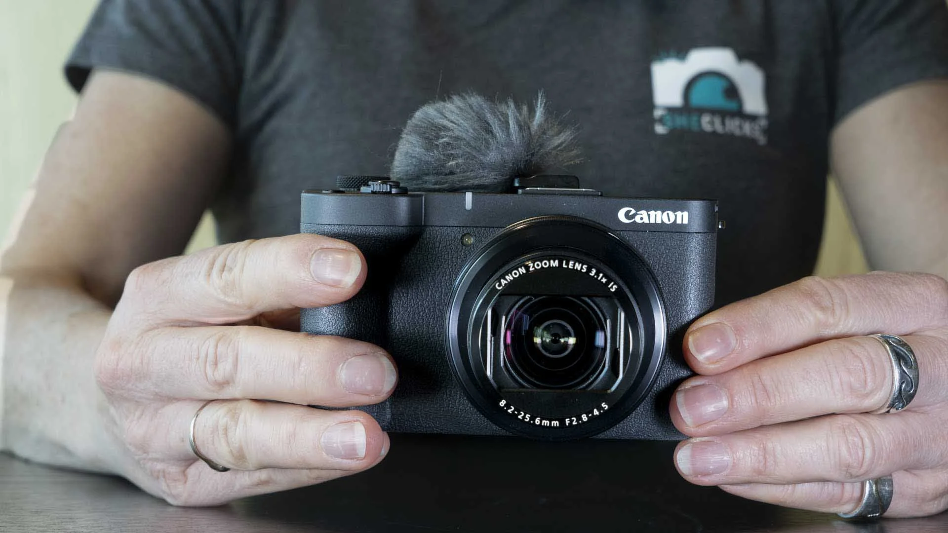 Canon supplies a wind muff with the PowerShot V1. This slots into the hotshoe and covers the onboard mic.